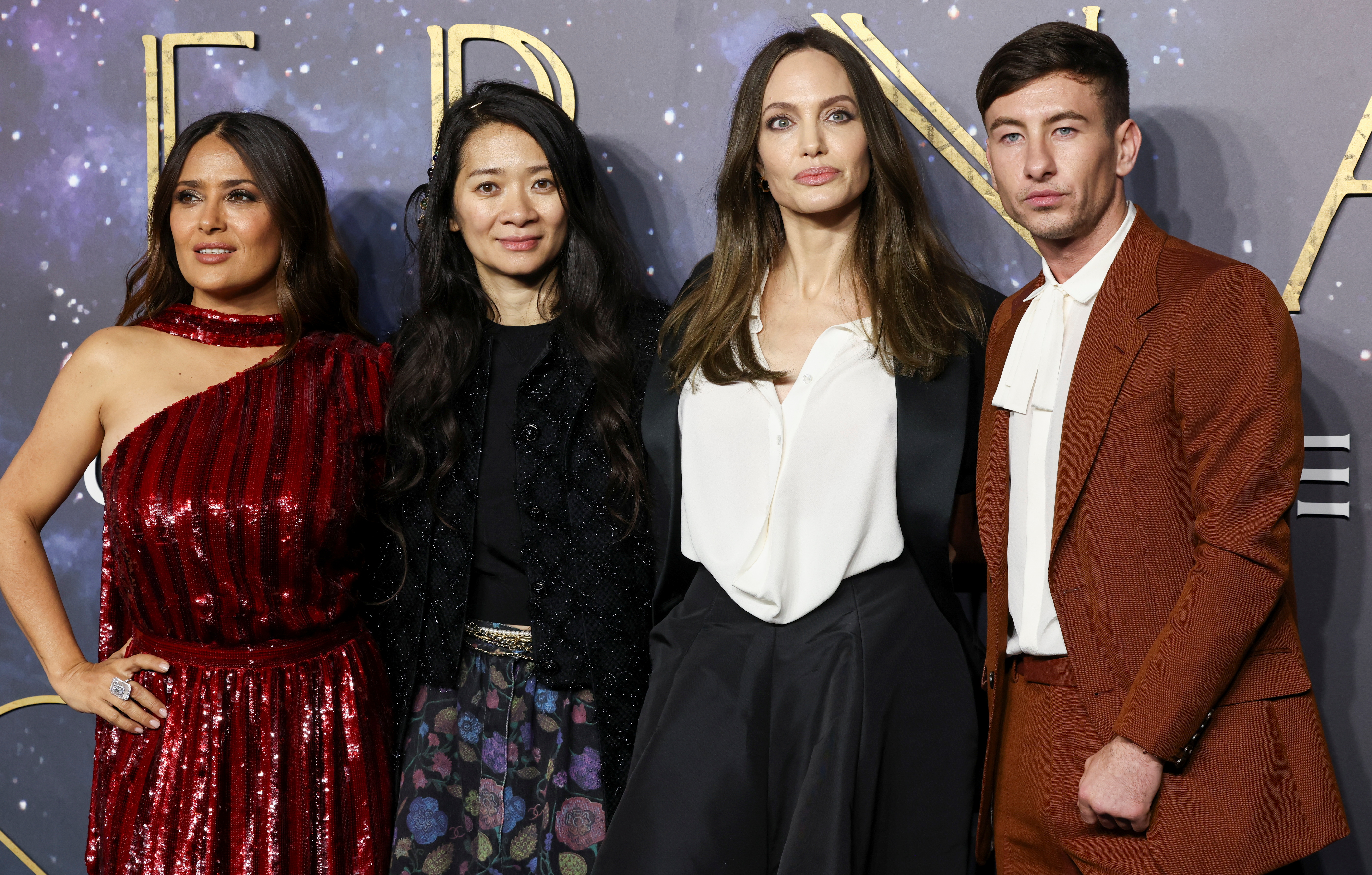 Director Chloe Zhao poses with cast members Salma Hayek, Angelina Jolie and Barry Keoghan as they arrive for a screening of the film "Eternals" in London, Britain, October 27, 2021. REUTERS/Henry Nicholls