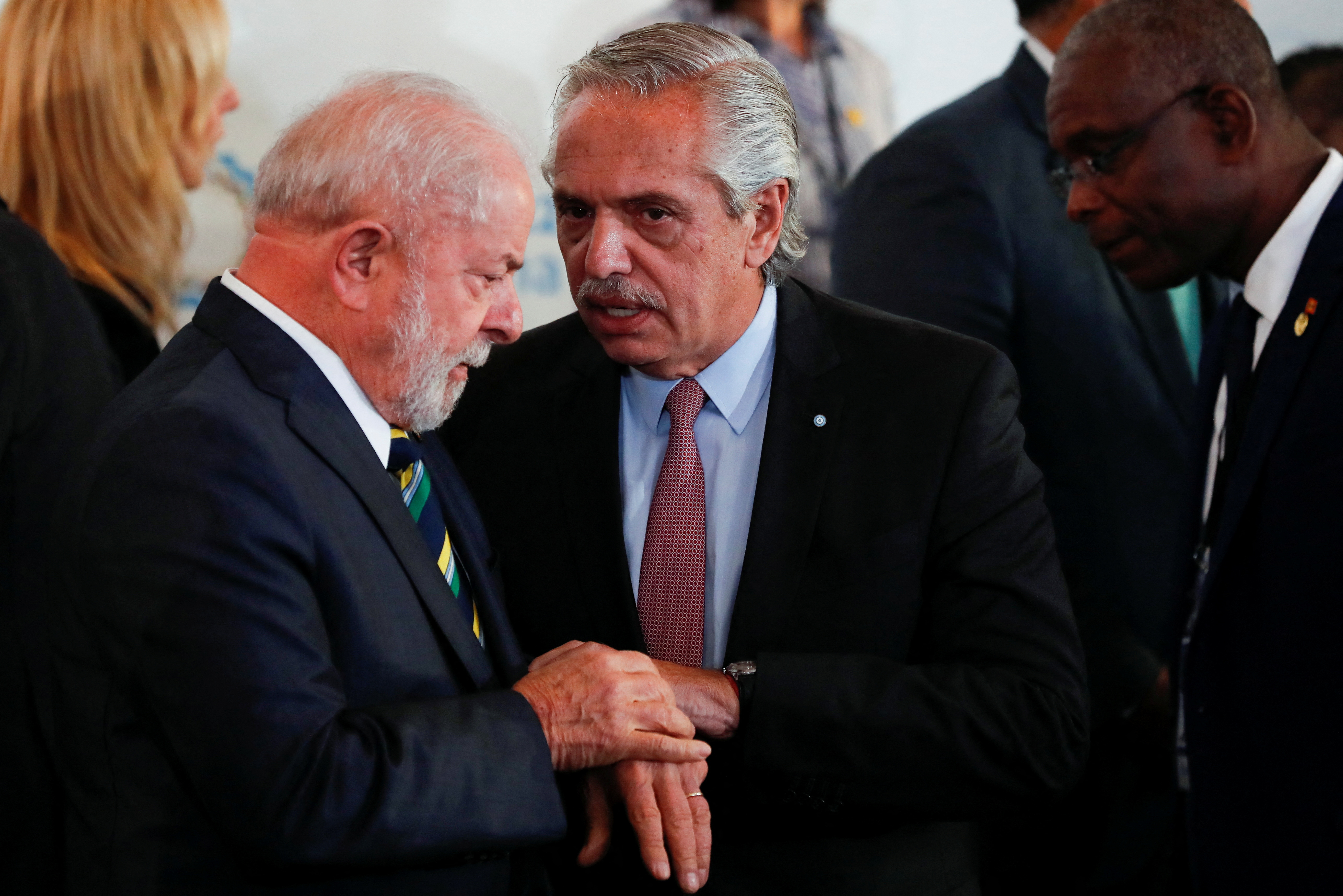 Brazil's President Luiz Inacio Lula da Silva and Argentina's President Alberto Fernandez talk as they stand for a family photo during the 7th Heads of State and Government Summit of the Community of Latin American and Caribbean States (CELAC) in Buenos Aires, Argentina, January 24, 2023. REUTERS/Agustin Marcarian