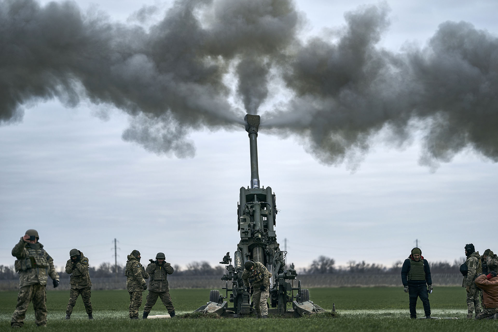 Ukrainian soldiers fire at Russian positions from a US-supplied M777 howitzer in the Kherson region of Ukraine on January 9, 2023. (AP Photo/Libkos)
