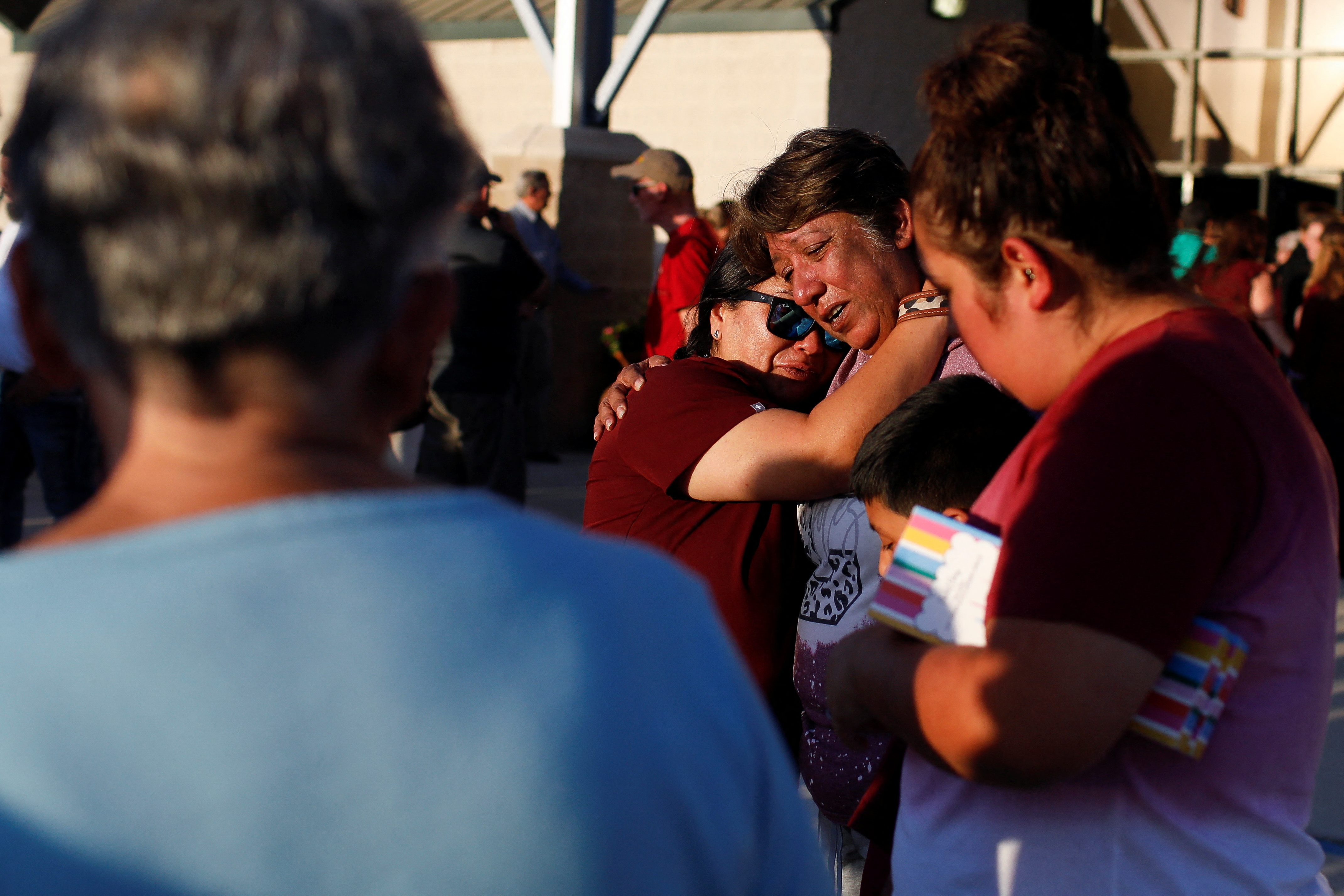 La gente se abraza un día después de que un hombre armado matara a 19 niños y dos profesores en la escuela primaria Robb, en el Uvalde County Fairplex Arena, en Uvalde, Texas, Estados Unidos, el 25 de mayo de 2022. REUTERS/Marco Bello