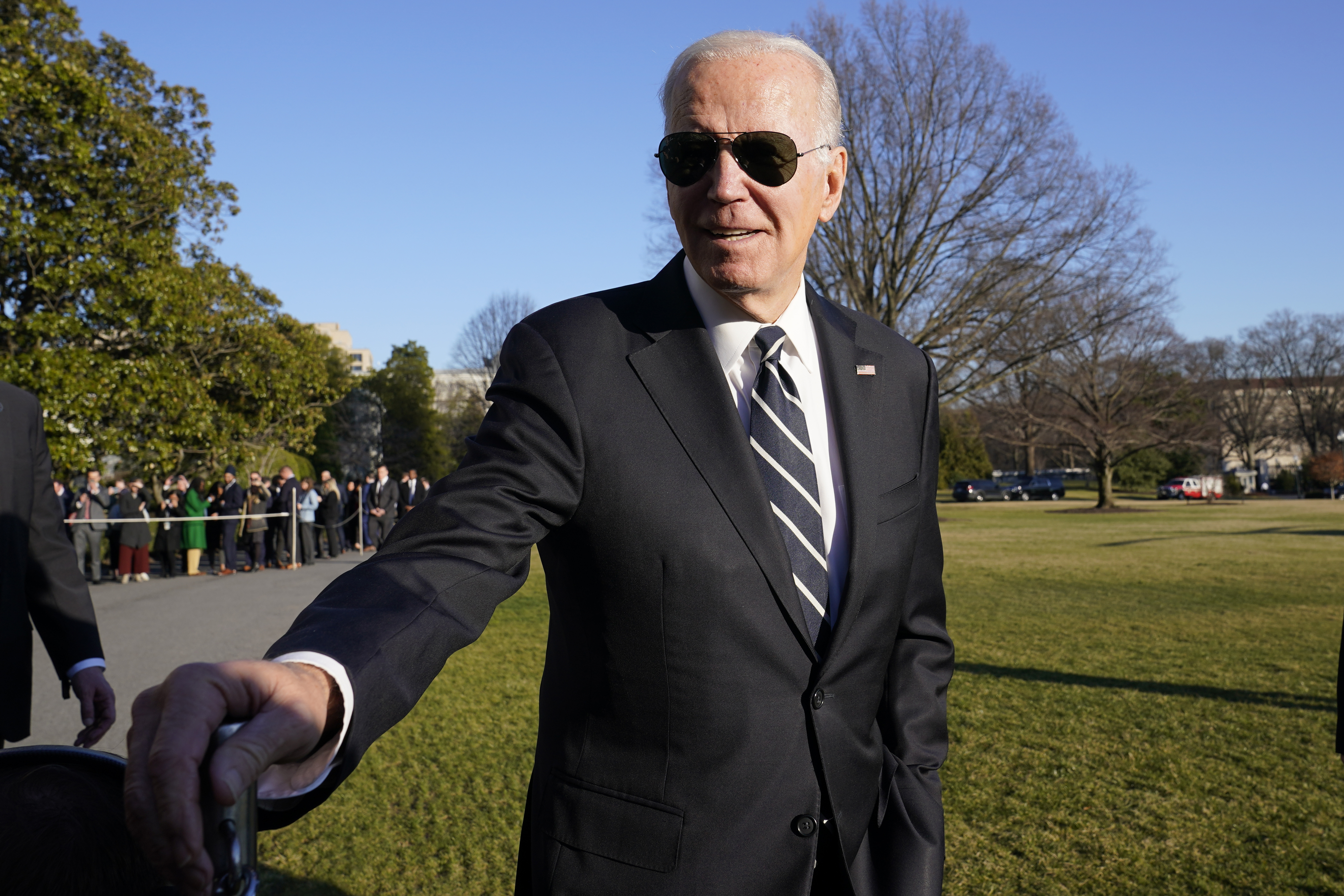President Joe Biden talks with reporters on the South Lawn of the White House Monday, Jan. 30, 2023, in Washington, after returning from an event in Baltimore on infrastructure.  (AP Photo/Susan Walsh)