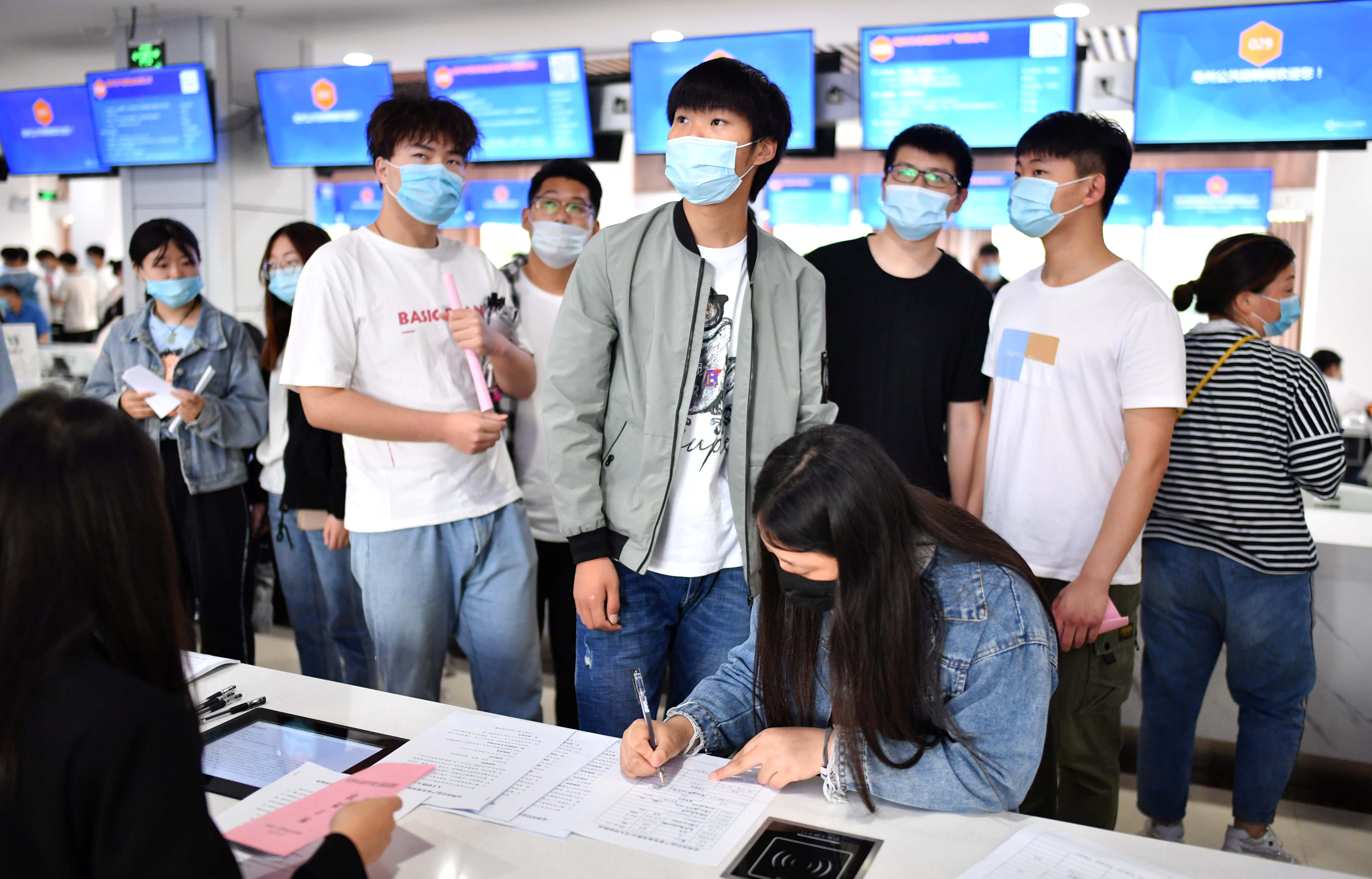 Foto de archivo: Jóvenes con mascarillas en la pandemia de COVID-19 asisten a una feria de empleo para graduados universitarios en Bozhou  (REUTERS)