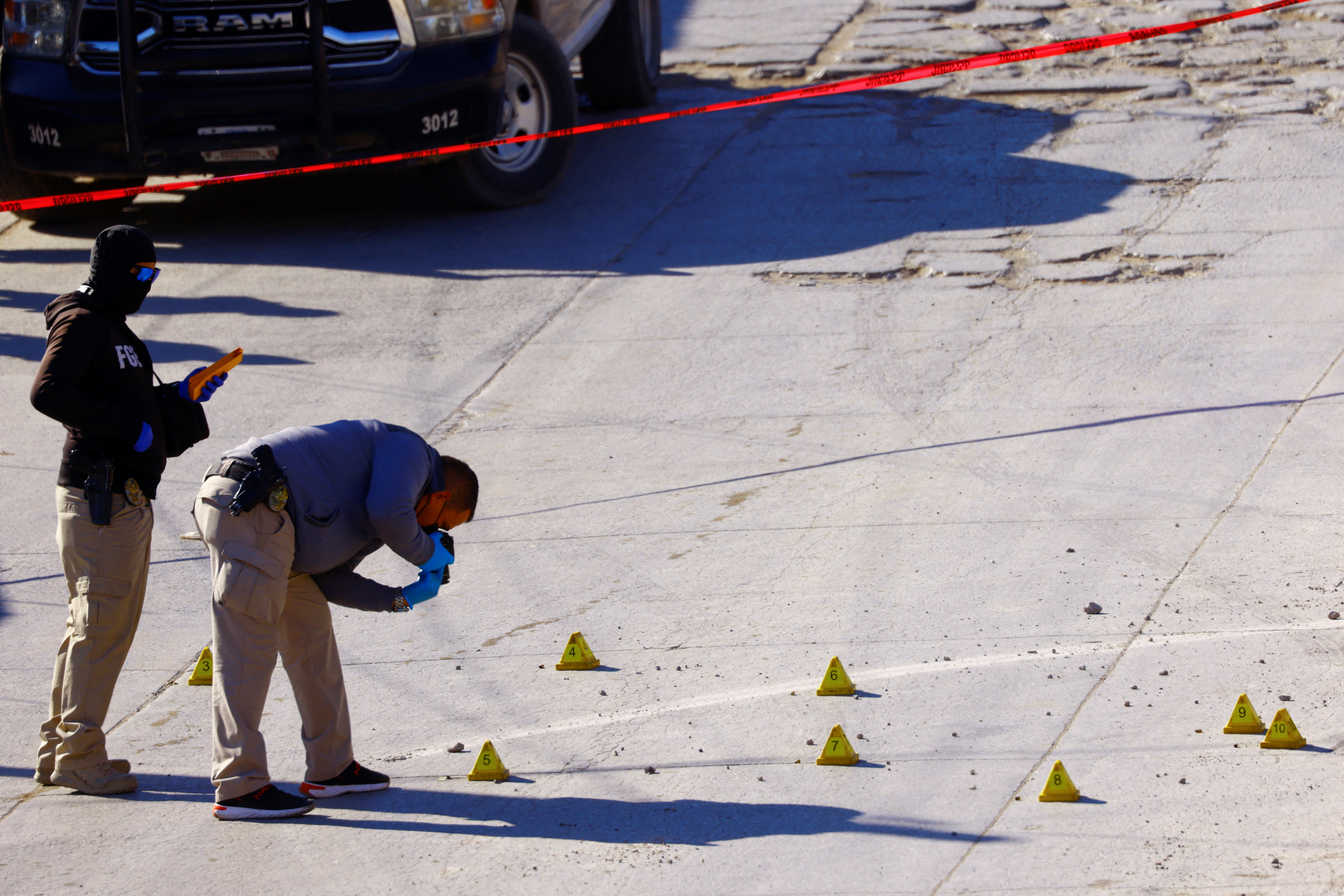 Forensic technicians work at the crime scene where unknown assailants killed four people during a wake, according to local media, in Ciudad Juarez, Mexico February 12, 2022. REUTERS/Jose Luis Gonzalez
