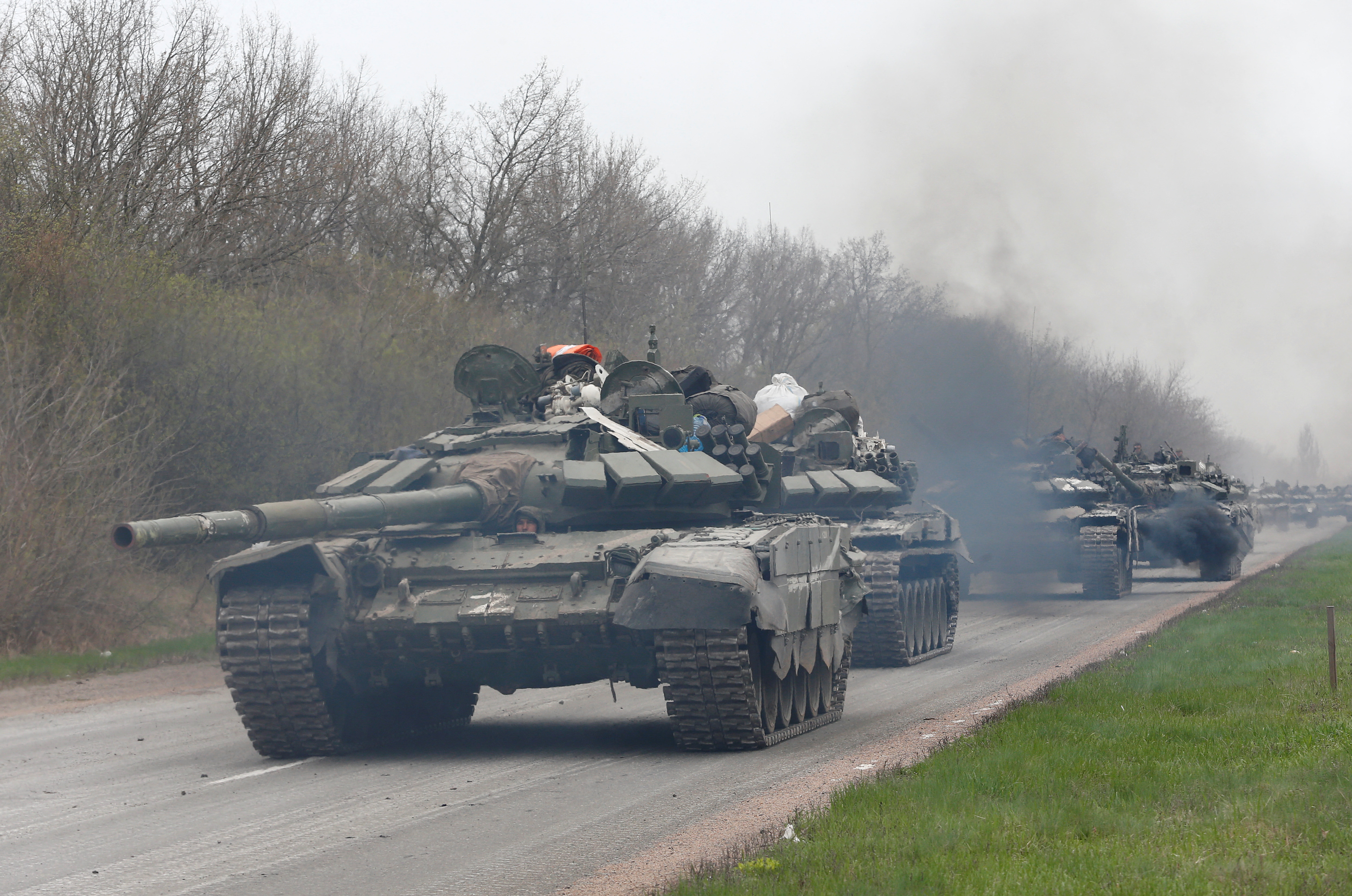 Service members of pro-Russian troops drive tanks near Mariupol