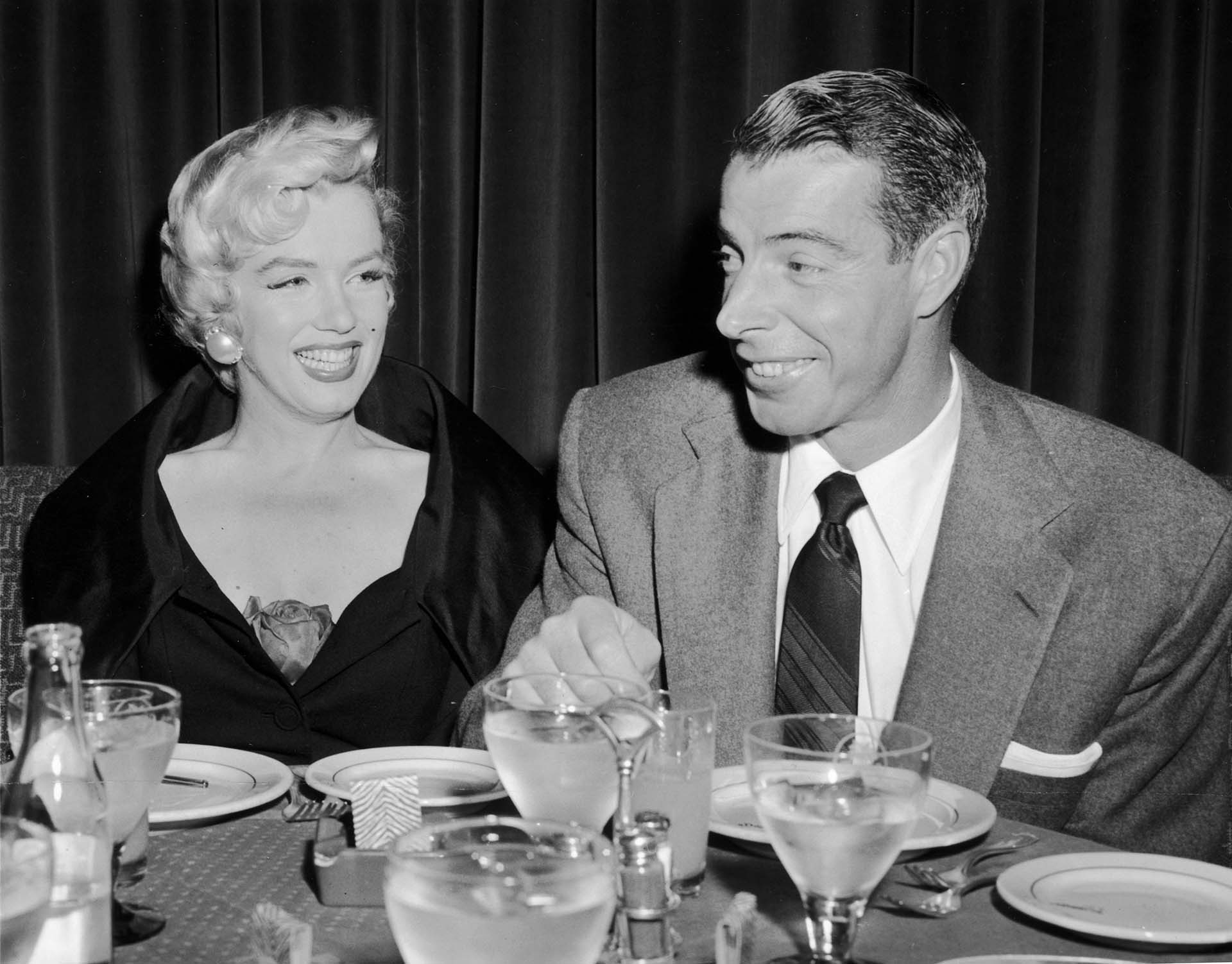 12th September 1954:  A portrait of Marilyn Monroe (1926  - 1962) sitting with her husband Joe DiMaggio (1914 - 1999) at El Morocco, New York City, New York.  (Photo by Hulton Archive/Getty Images)