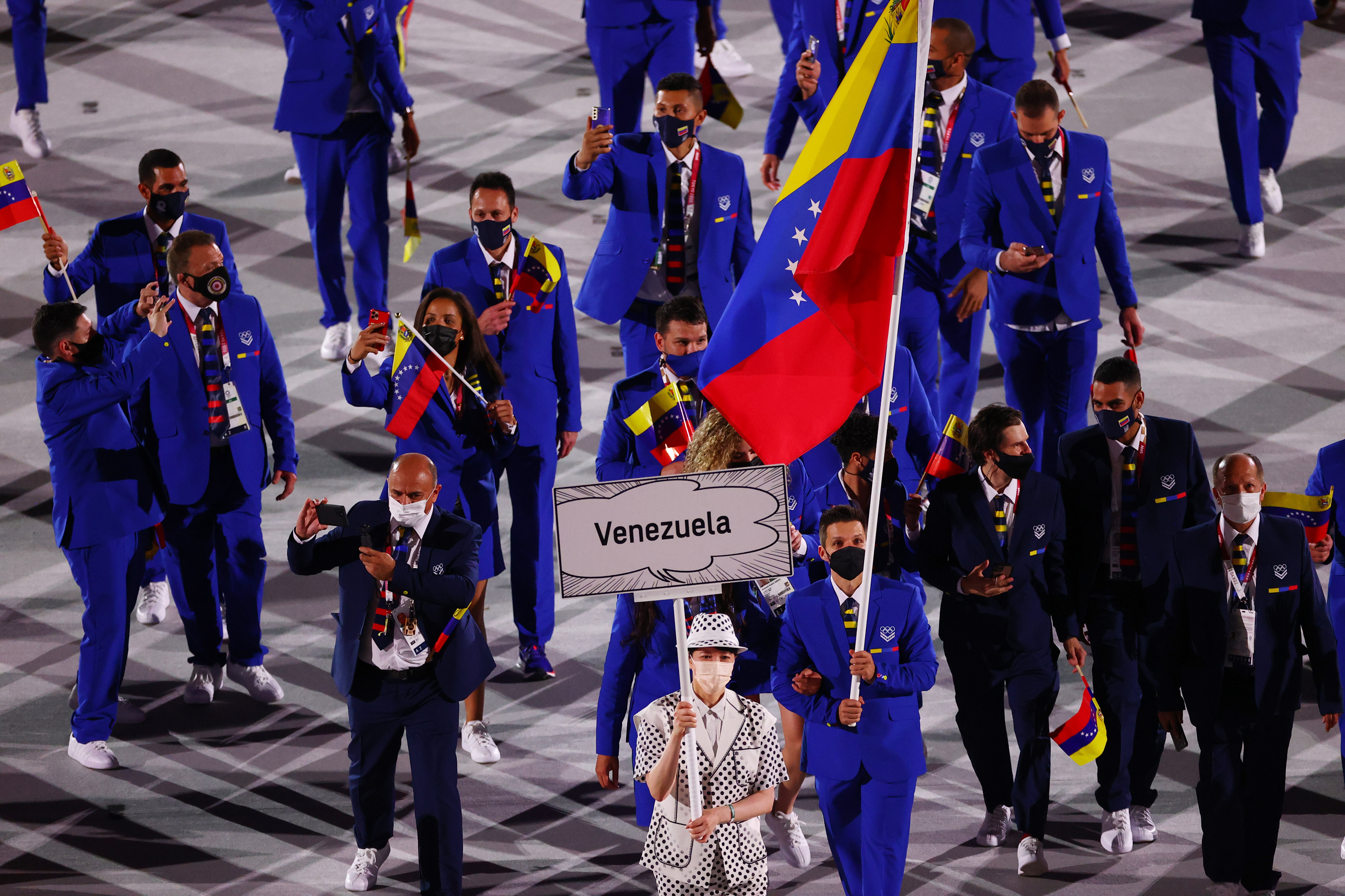 Tokyo 2020 Olympics - The Tokyo 2020 Olympics Opening Ceremony - Olympic Stadium, Tokyo, Japan - July 23, 2021. Flag bearers Karen Leon of Venezuela and Antonio Diaz of Venezuela lead their contingent during the athletes parade at the opening ceremony REUTERS/Mike Blake