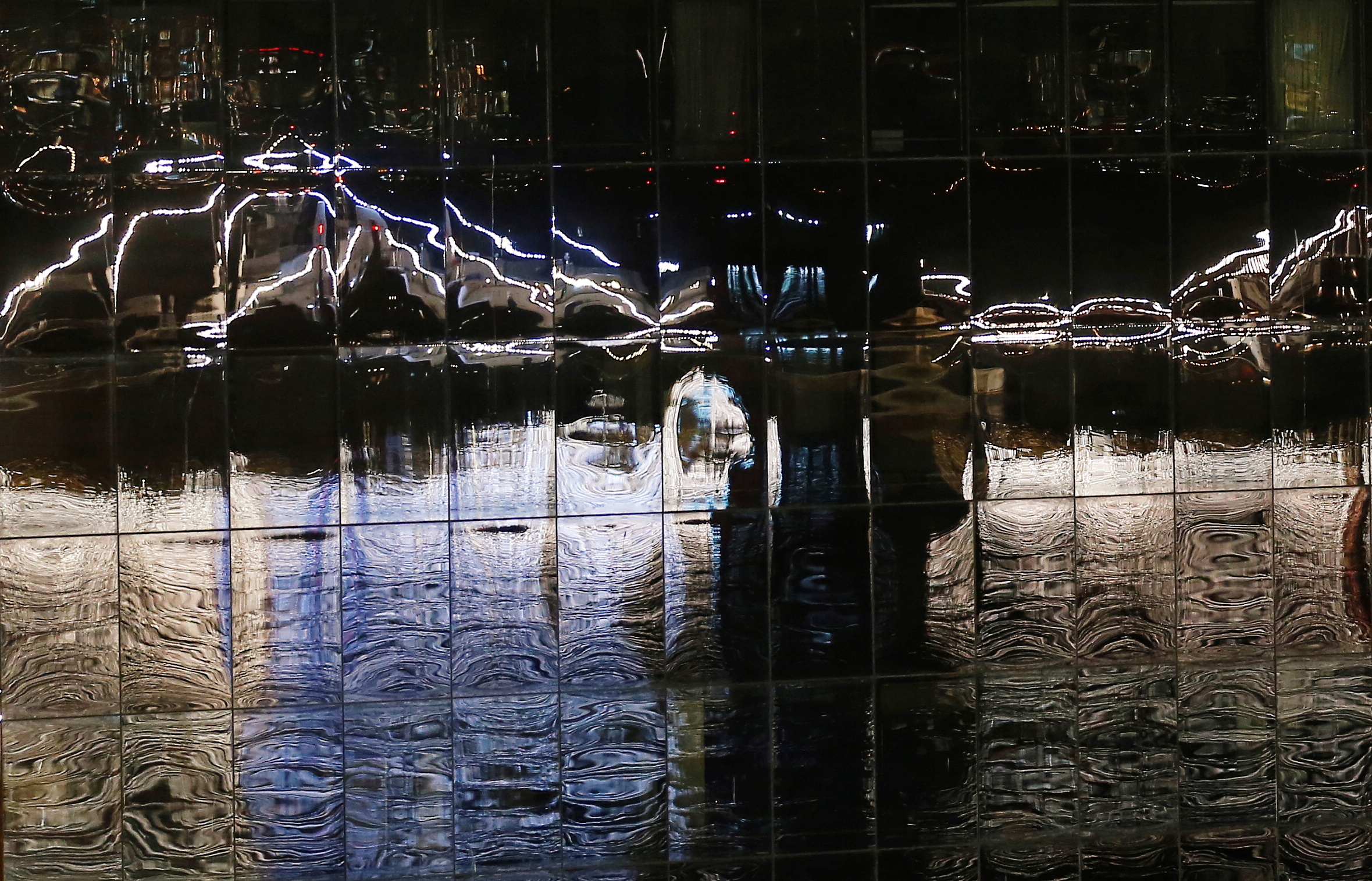 Ships of the Chilean Navy decorated with lights as part of the New Year's Eve celebrations are reflected on a building, after Chile's Health Ministry canceled the traditional fireworks due to the outbreak of the coronavirus disease (COVID-19), in Valparaiso, Chile January 1, 2021. REUTERS/Rodrigo Garrido