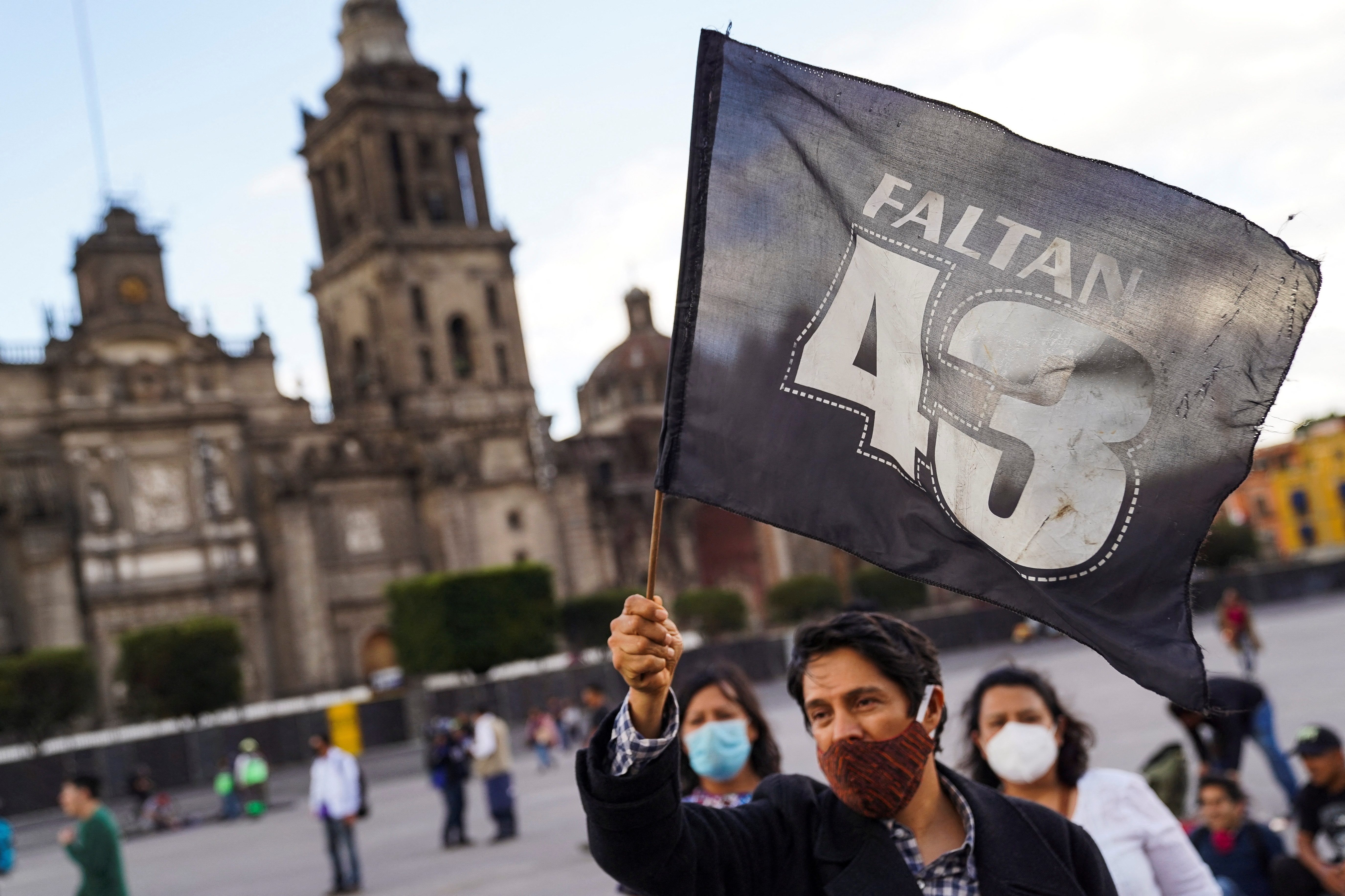 A man waves a flag reading "43 are missing" during a march to mark the 8th anniversary since the disappearance of the 43 students of the Ayotzinapa College "Raul Isidro Burgos" in the state of Guerrero, in Mexico City, Mexico, September 26, 2022. REUTERS/Toya Sarno Jordan