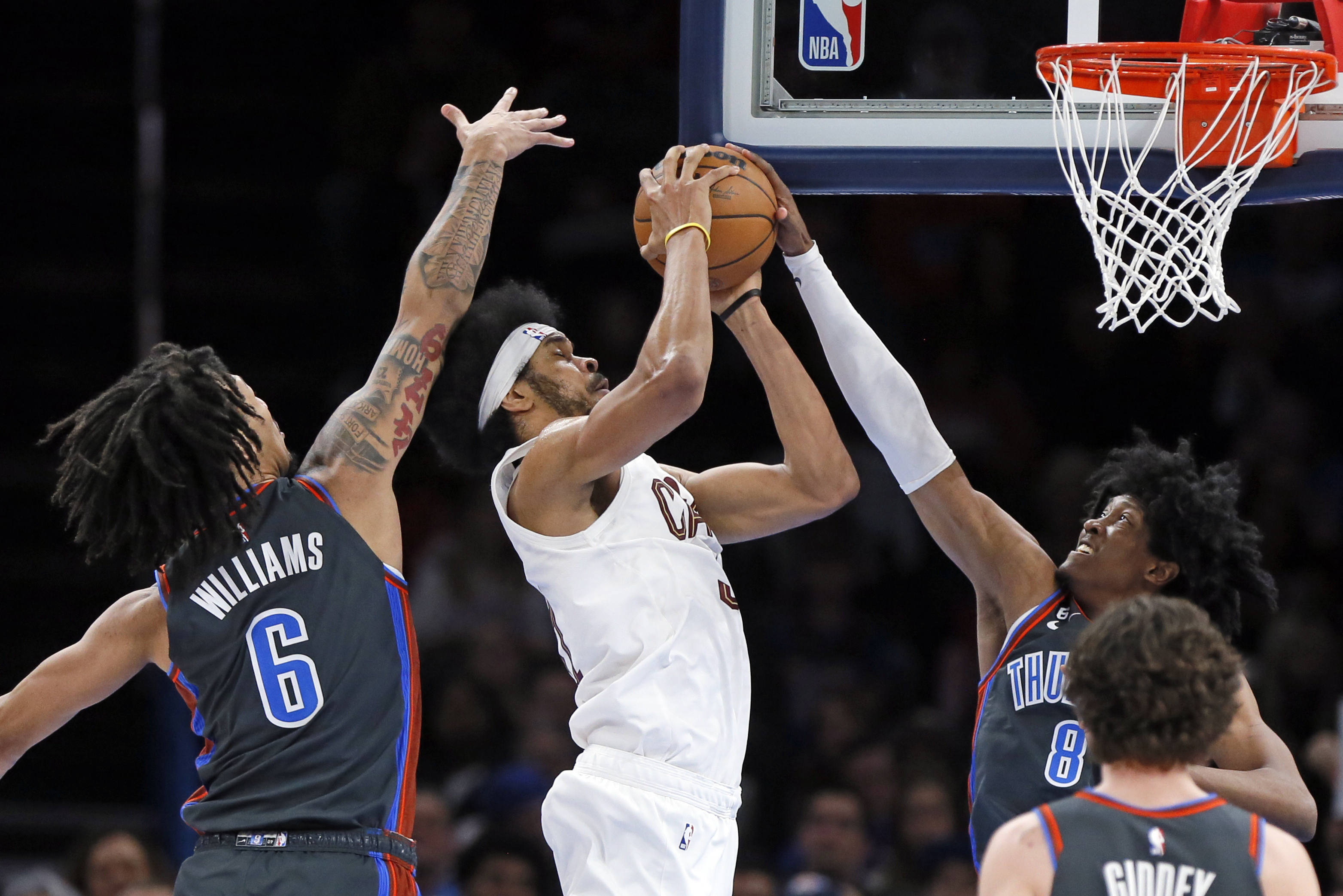 Oklahoma City Thunder's Jalen Williams, right, blocks a shot attempt by Cleveland Cavaliers' Jarrett Allen, while teammate Jaylin Williams also defends, during the second half of an NBA basketball game Friday January 27, 2023, in Oklahoma City.  (AP Photo/Nate Billings)
