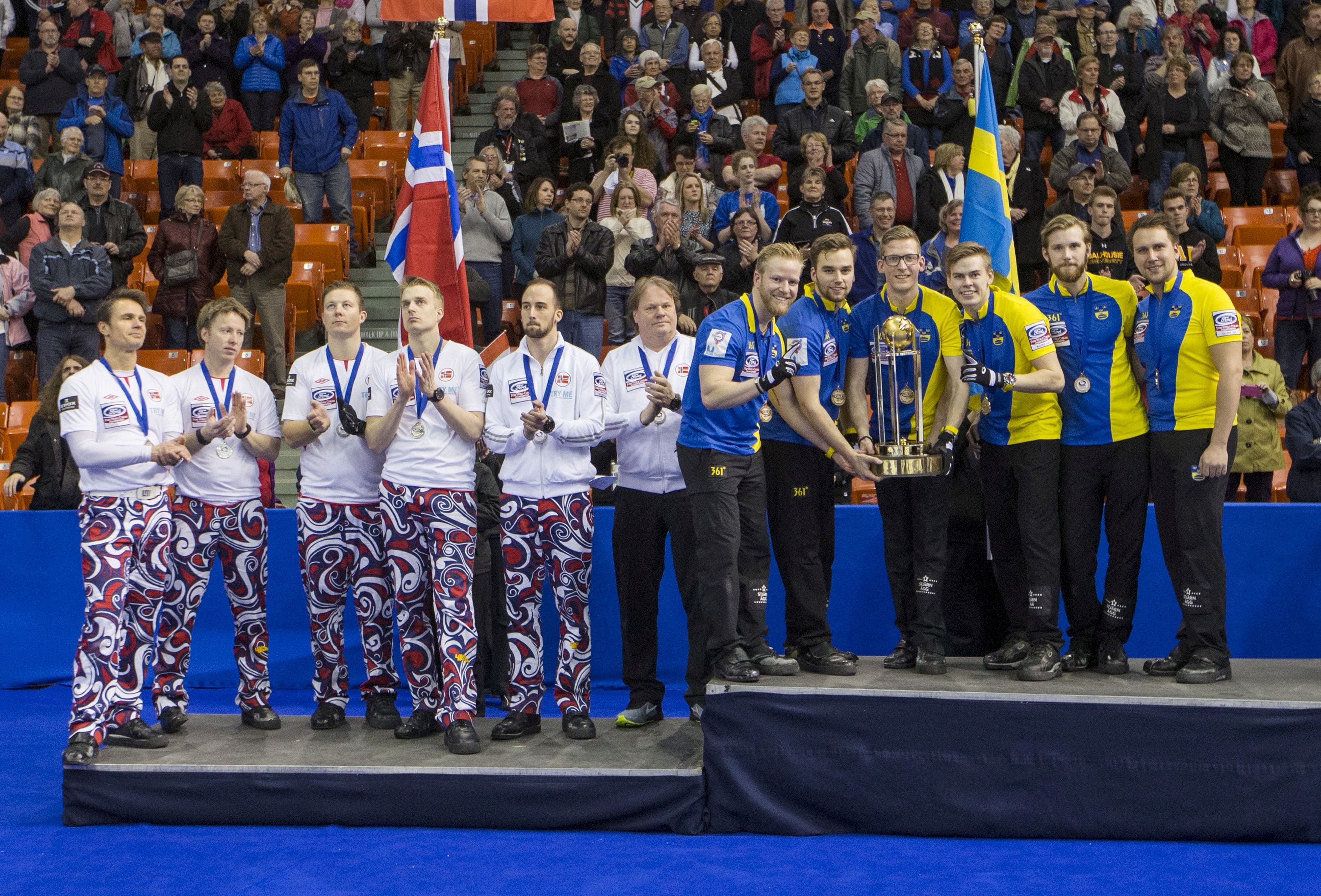 FILE PHOTO: ON THIS DAY -- April 5  April 5, 2015     CURLING - Sweden celebrate with the trophy after defeating Norway 9-5 in the gold medal match at the World Curling Championships in Halifax, Nova Scotia.     Sweden skip Niklas Edin helped his side score three points in the first, third and seventh ends to secure the victory and avenge their defeat by Norway in the previous year's final.     Edin led Sweden to back-to-back world championship gold medals in 2018 and 2019, as well as a silver medal in the 2018 Winter Olympics in Pyeongchang. REUTERS/Mark Blinch/File Photo