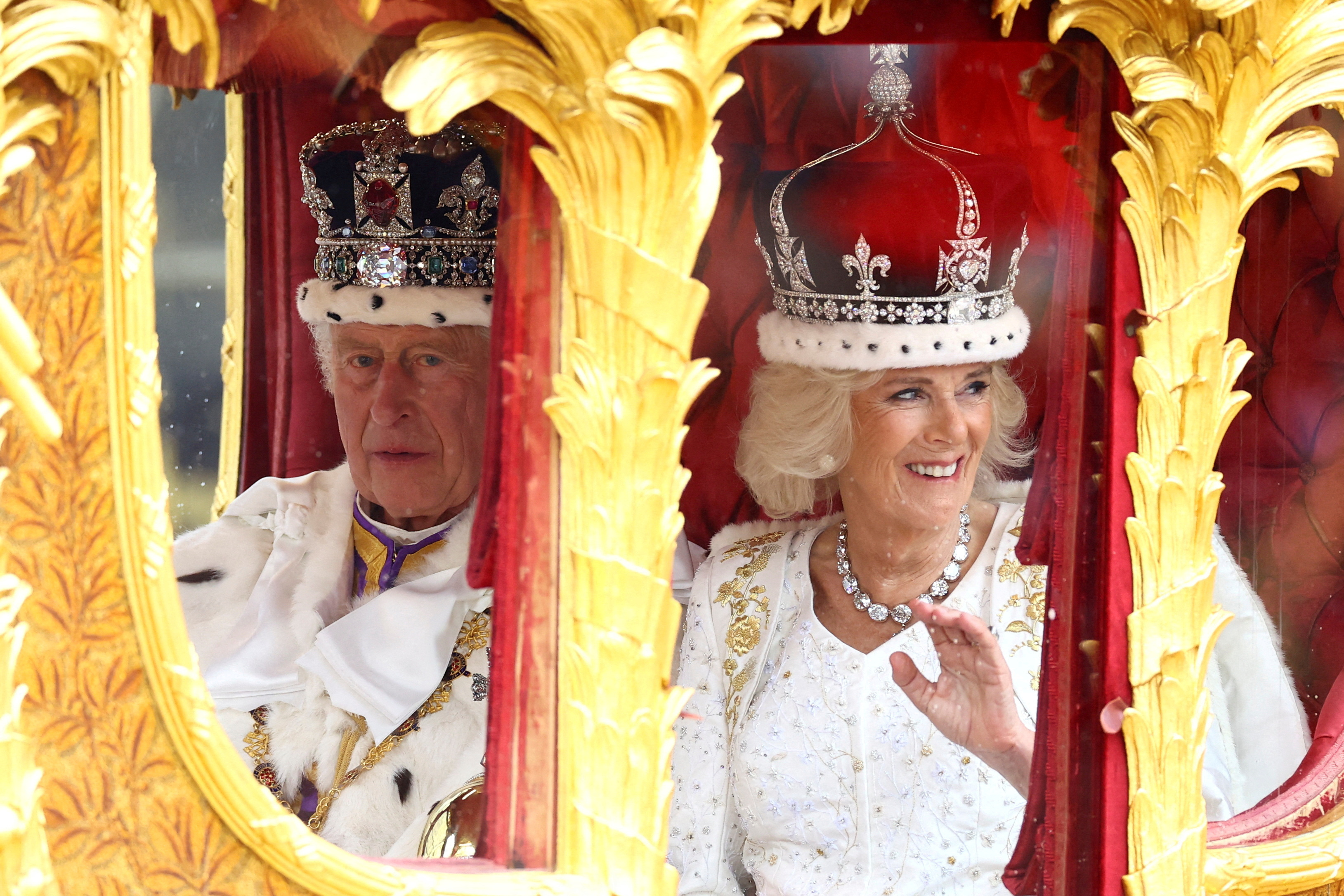Britain's King Charles and Queen Camilla travel from Westminster Abbey in the Gold State Coach, following their coronation ceremony, in London, Britain, May 6, 2023. REUTERS/Lisi Niesner SEARCH "CORONATION IMAGES" FOR THIS STORY.  SEARCH "WIDE IMAGE" FOR ALL STORIES.  TPX IMAGES OF THE DAY