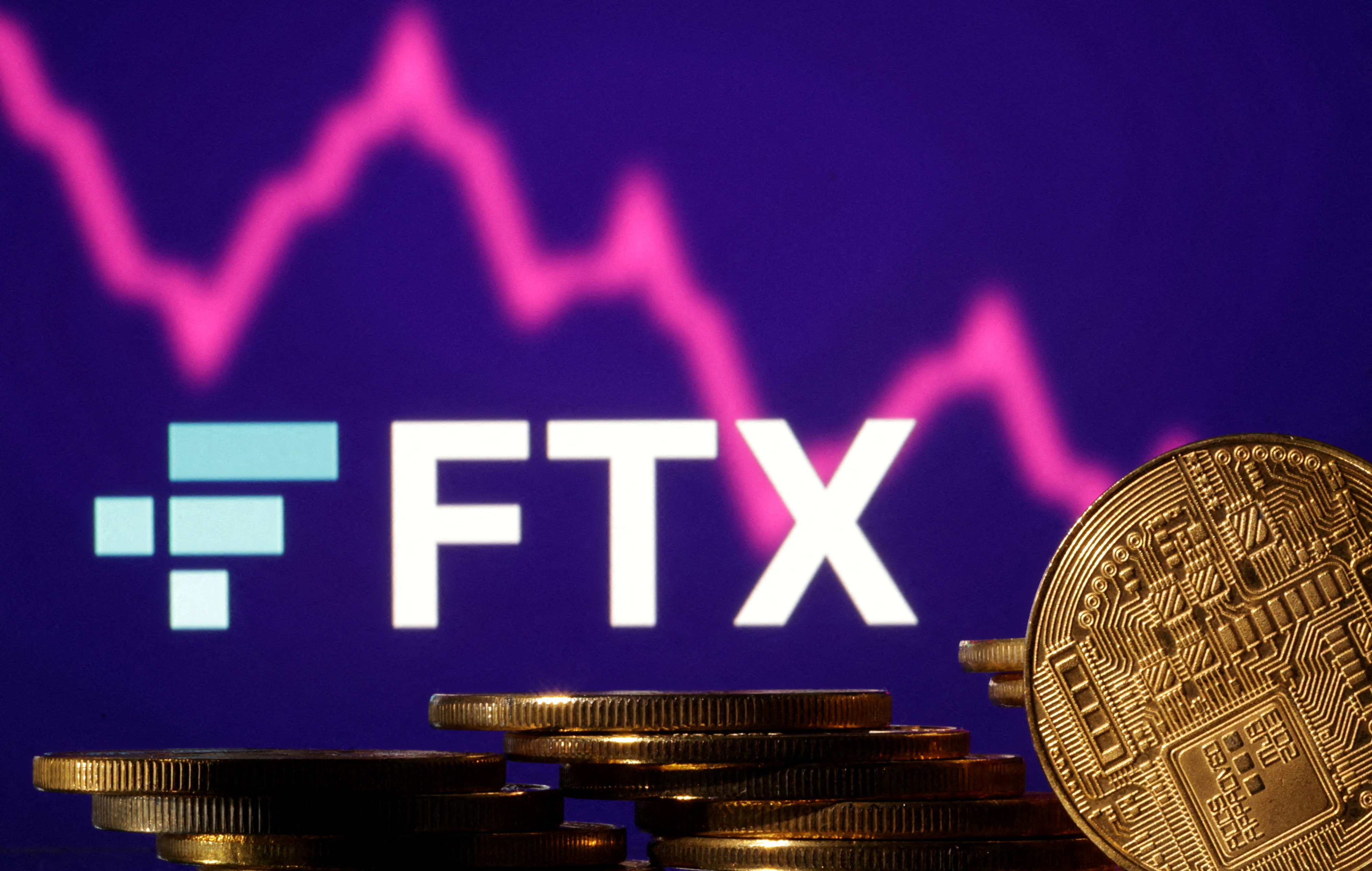 FILE PHOTO: Representations of cryptocurrencies are seen in front of displayed FTX logo and decreasing stock graph in this illustration taken November 10, 2022. REUTERS/Dado Ruvic/Illustration/File Photo