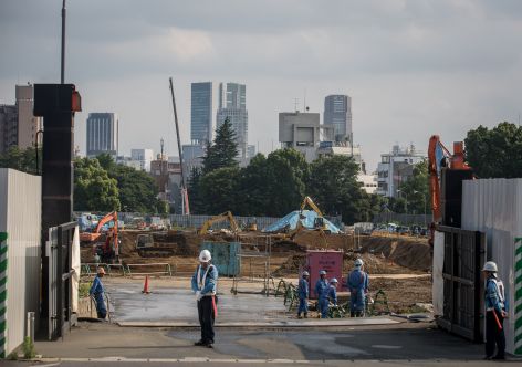 TOKYO, JAPAN - JUNE 25: Work continues at the site of the new National stadium and the planned main site of the Tokyo 2020 summer Olympics on June 25, 2015 in Tokyo, Japan. Despite heavy criticism from respected Japanese architects and a 90 billion yen price rise since Iraqi-British architect Zaha Hadid's design was originally selected in 2012.  Japan announced in a report on June 24, that it will continue with construction but have altered the design in an attempt to cut costs.  (Photo by Chris McGrath/Getty Images)