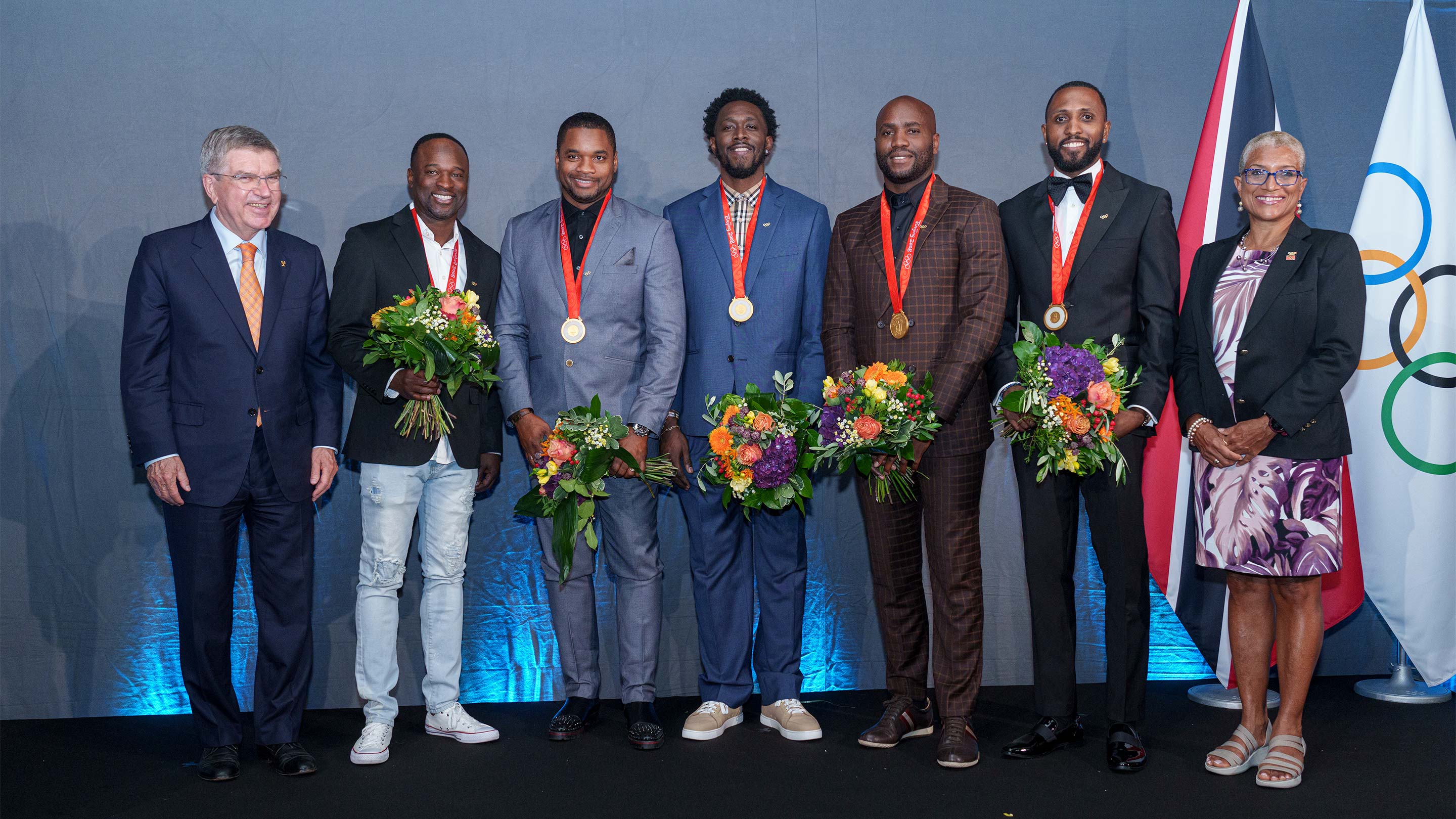 On Tuesday, IOC president, Thomas Bach, awarded the gold medals to Richard Thompson, Keston Bledman, Emmanuel Callander, Marc Burns and Aaron Armstrong with Trinidad and Tobago National Olympic Committee President Diane Henderson standing by.