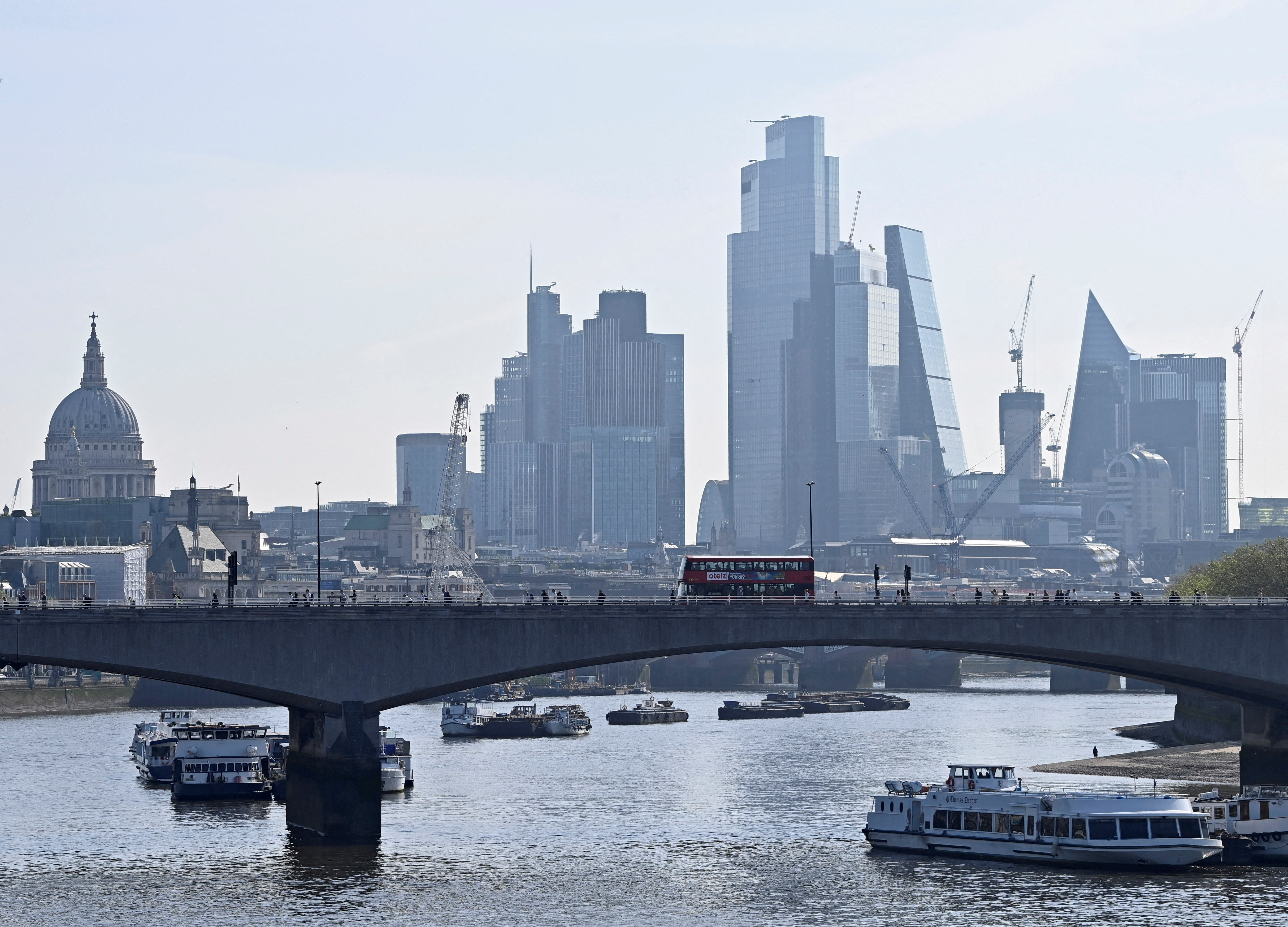 Boats are docked in the River Thames, with buildings in the City of London's financial district behind, in London, England, May 17, 2023. REUTERS/Toby Melville/File