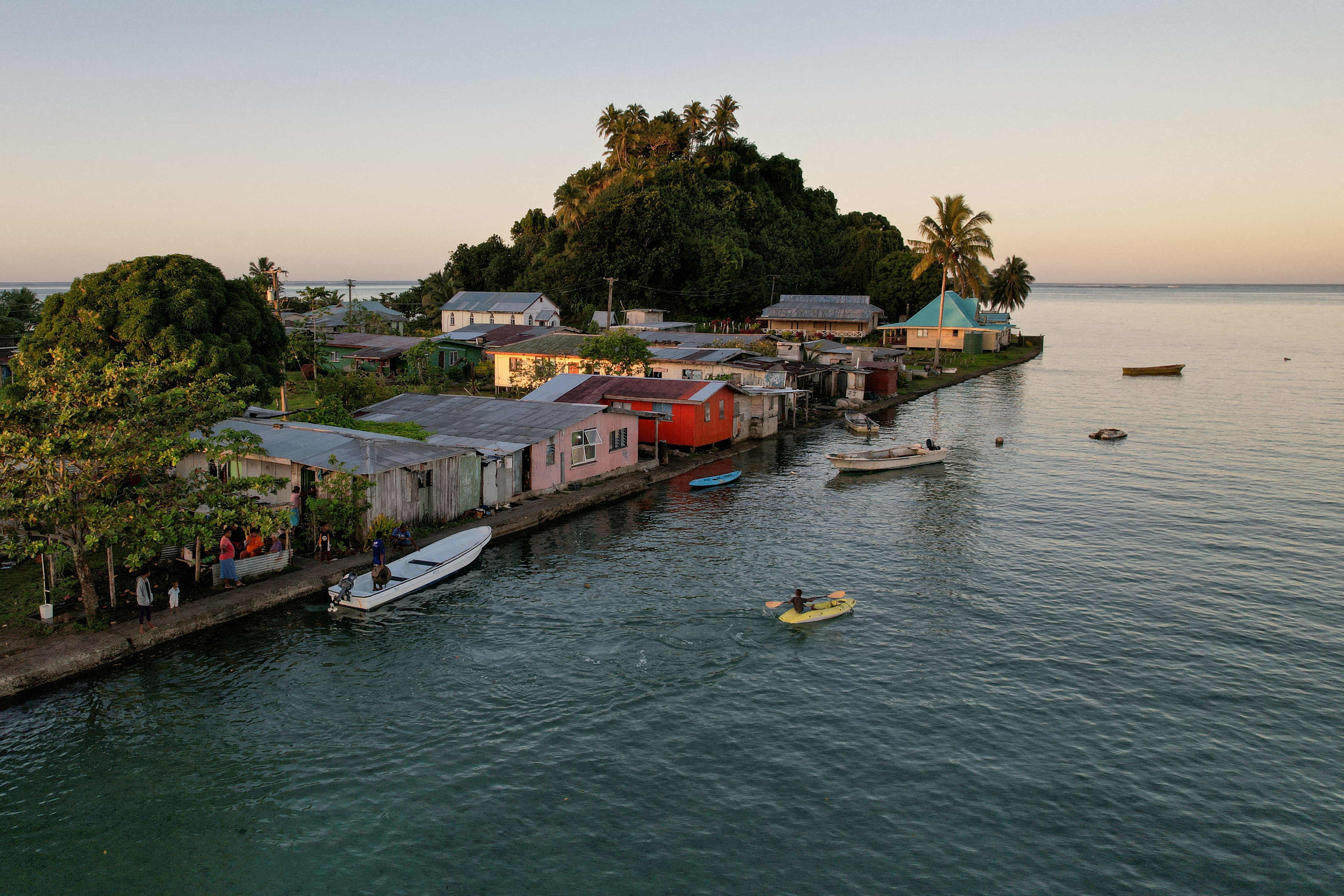 FILE PHOTO: The morning's first rays of sunlight hit the island community of Serua Village, Fiji, July 15, 2022. REUTERS/Loren Elliott/File Photo/File Photo