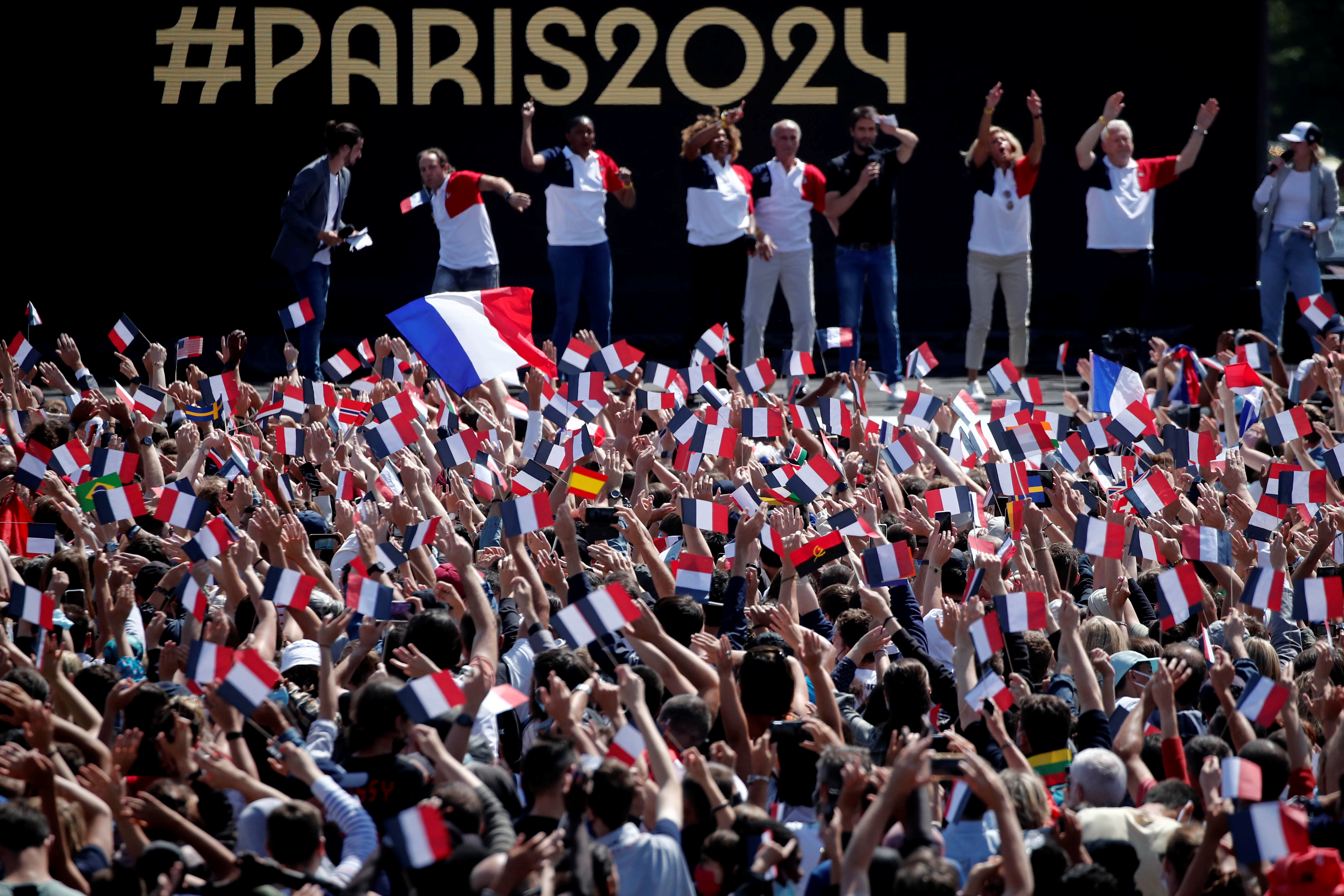 People gather at Paris' Olympics fan zone to watch the closing ceremony of the Tokyo games, in front of the Eiffel Tower, at Trocadero Gardens in Paris, France, August 8, 2021. REUTERS/Benoit Tessier
