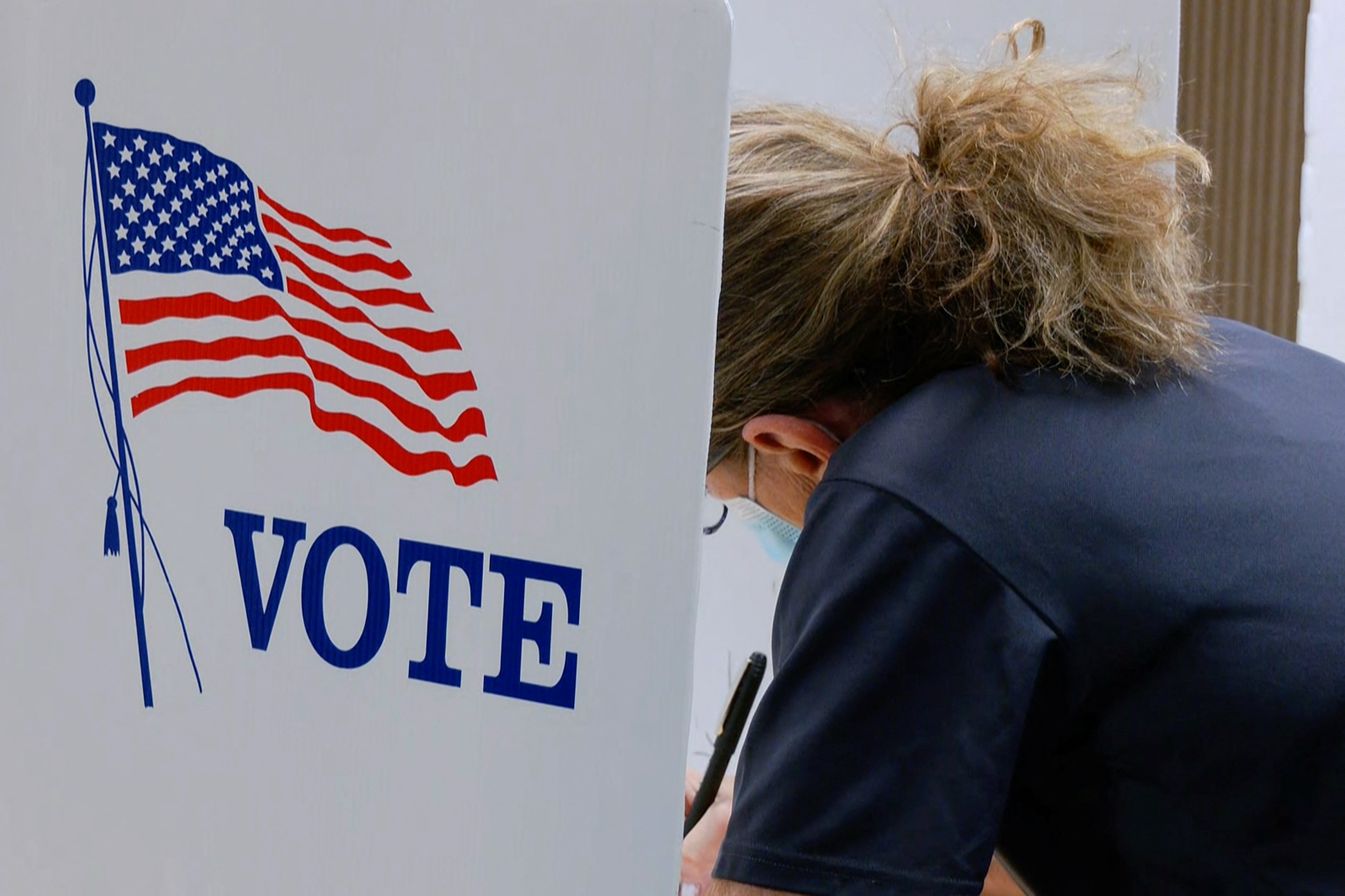 A voter marks a ballot during the primary election and abortion referendum at a Wyandotte County polling place in Kansas City, Kansas