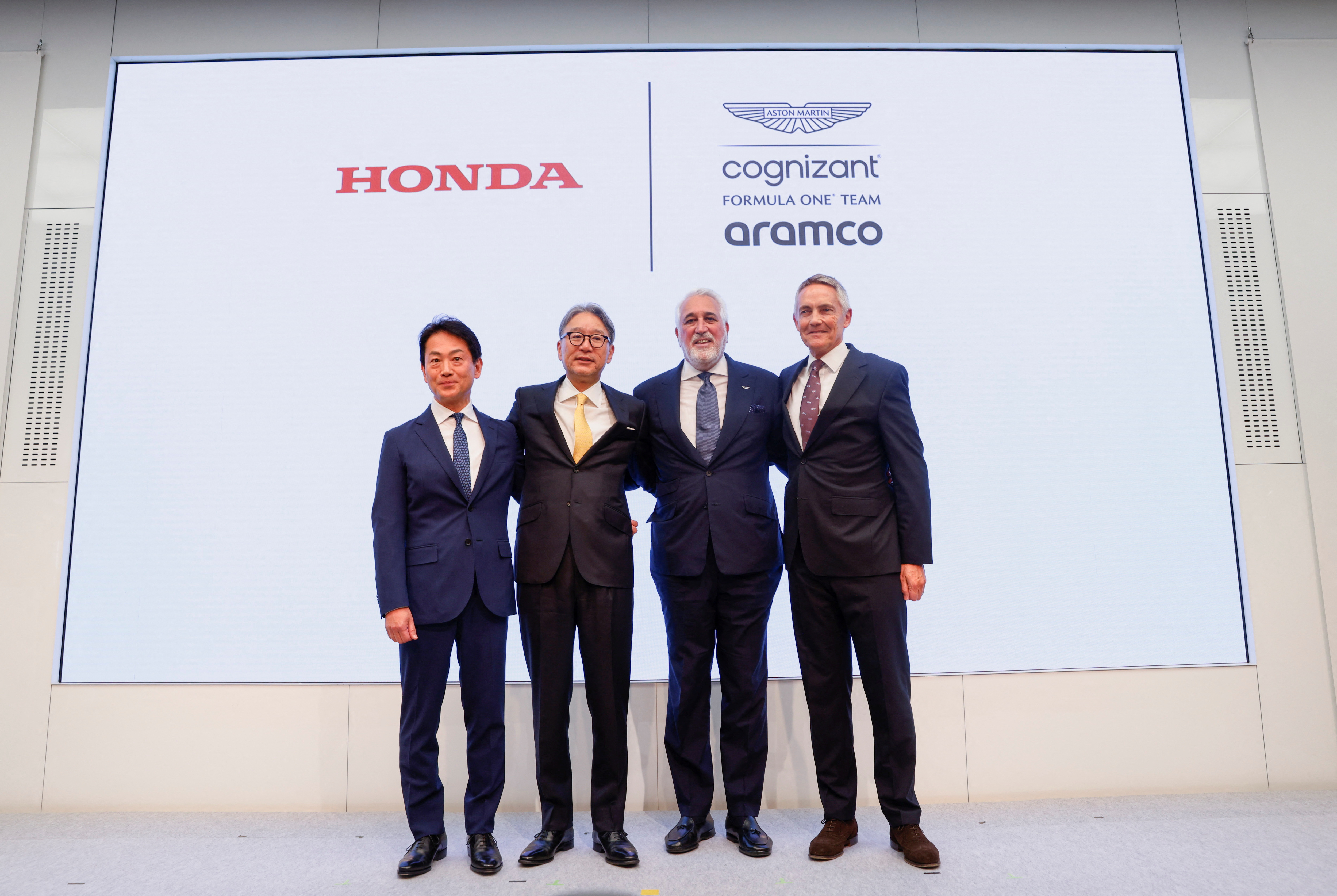 Honda Motor CEO Toshihiro Mibe, Honda Racing Corporation President Koji Watanabe, Aston Martin Aramco Cognizant Formula One Team Chairman Lawrence Stroll, Aston Martin Performance Technologies group CEO Martin Whitmarsh pose for a photograph during a news conference on their auto motorsports activities in Tokyo, Japan May 24, 2023. REUTERS/Issei Kato