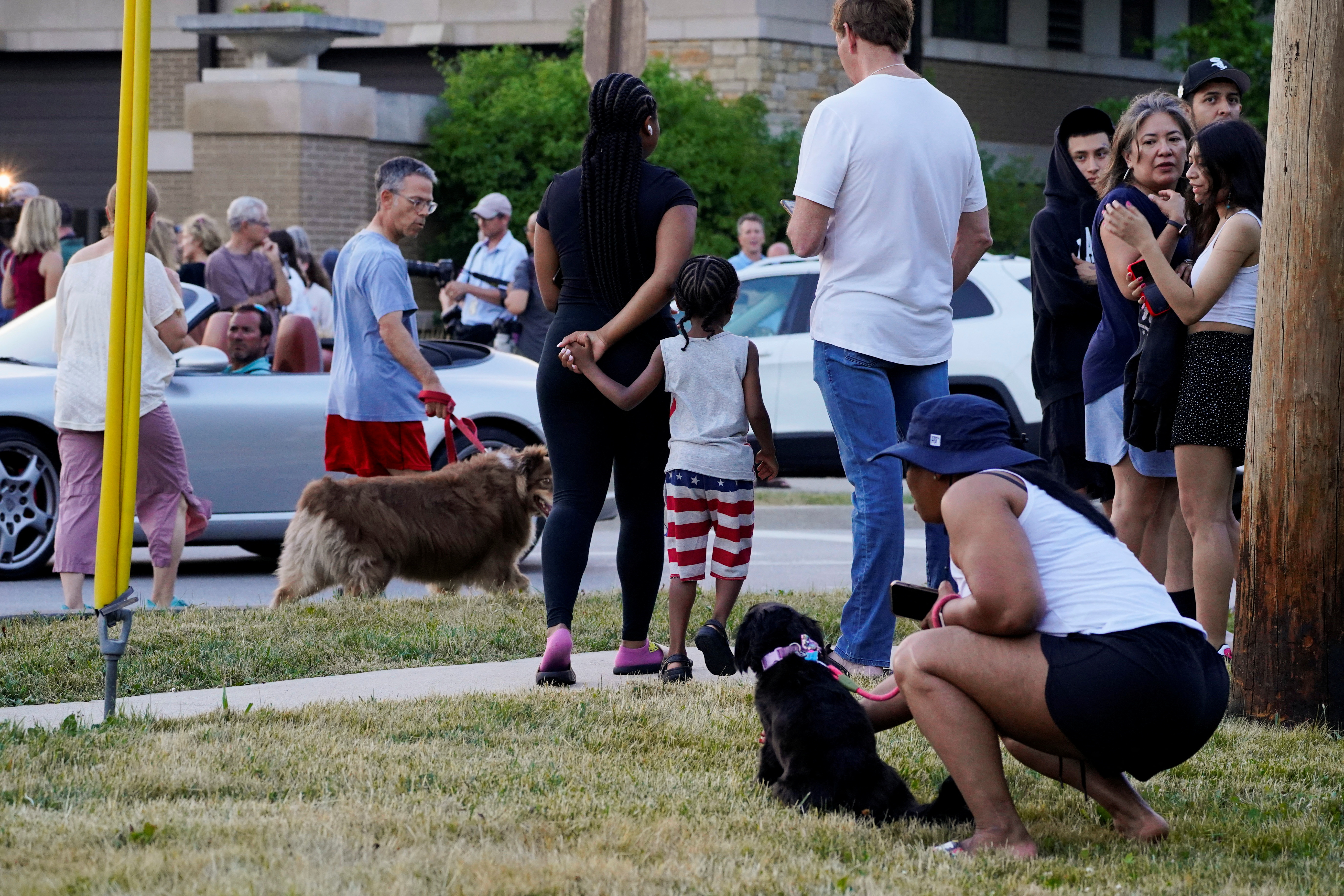 Community members wait outside the Highland Park Police station after a mass shooting at a Fourth of July parade route in the Chicago suburb of Highland Park, Illinois, U.S. July 4, 2022.  REUTERS/Cheney Orr