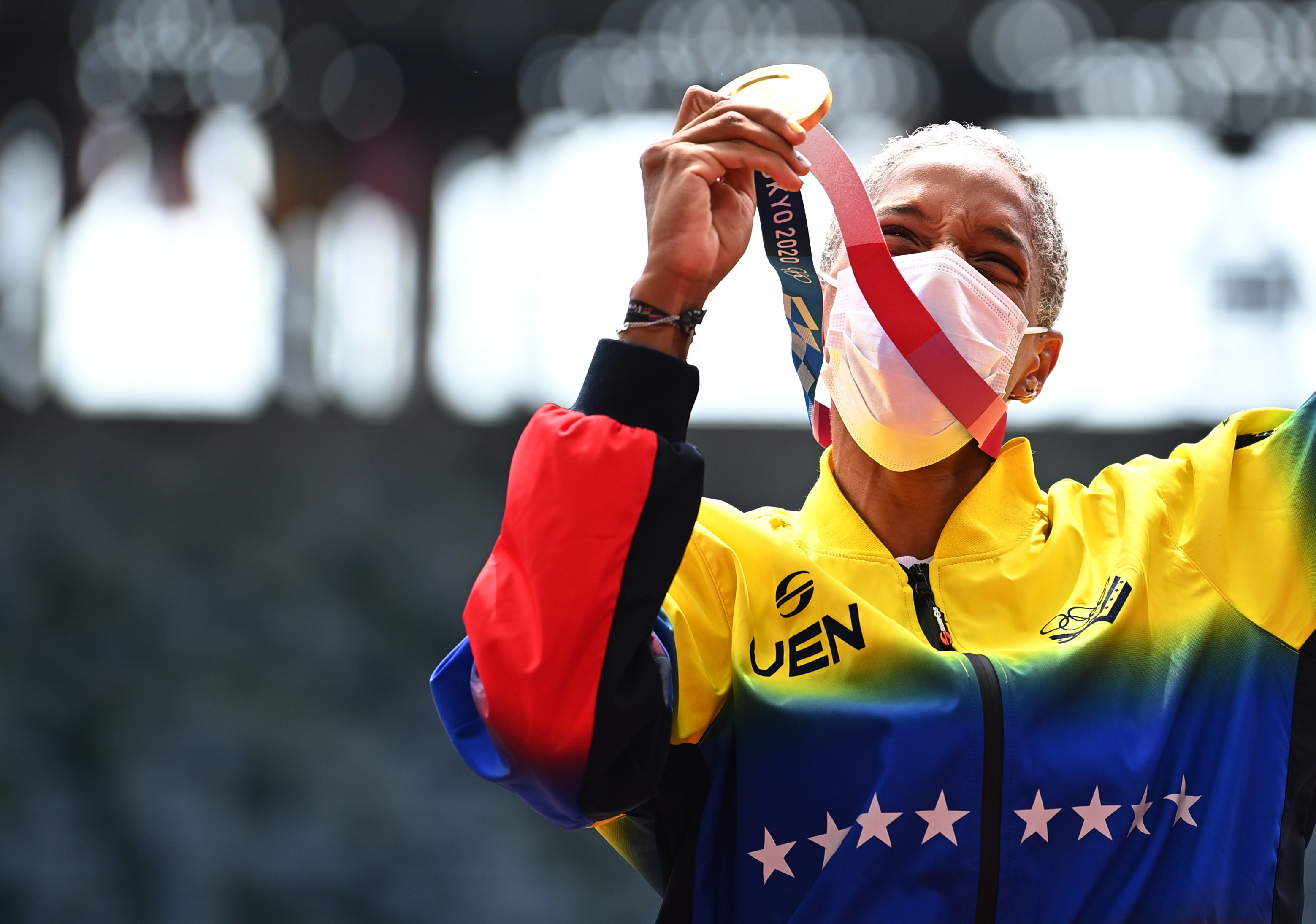 Tokyo 2020 Olympics - Athletics - Women's Triple Jump - Medal Ceremony - Olympic Stadium, Tokyo, Japan - August 2, 2021. Gold medallist, Yulimar Rojas of Venezuela celebrates on the podium wearing a protective face mask REUTERS/Dylan Martinez