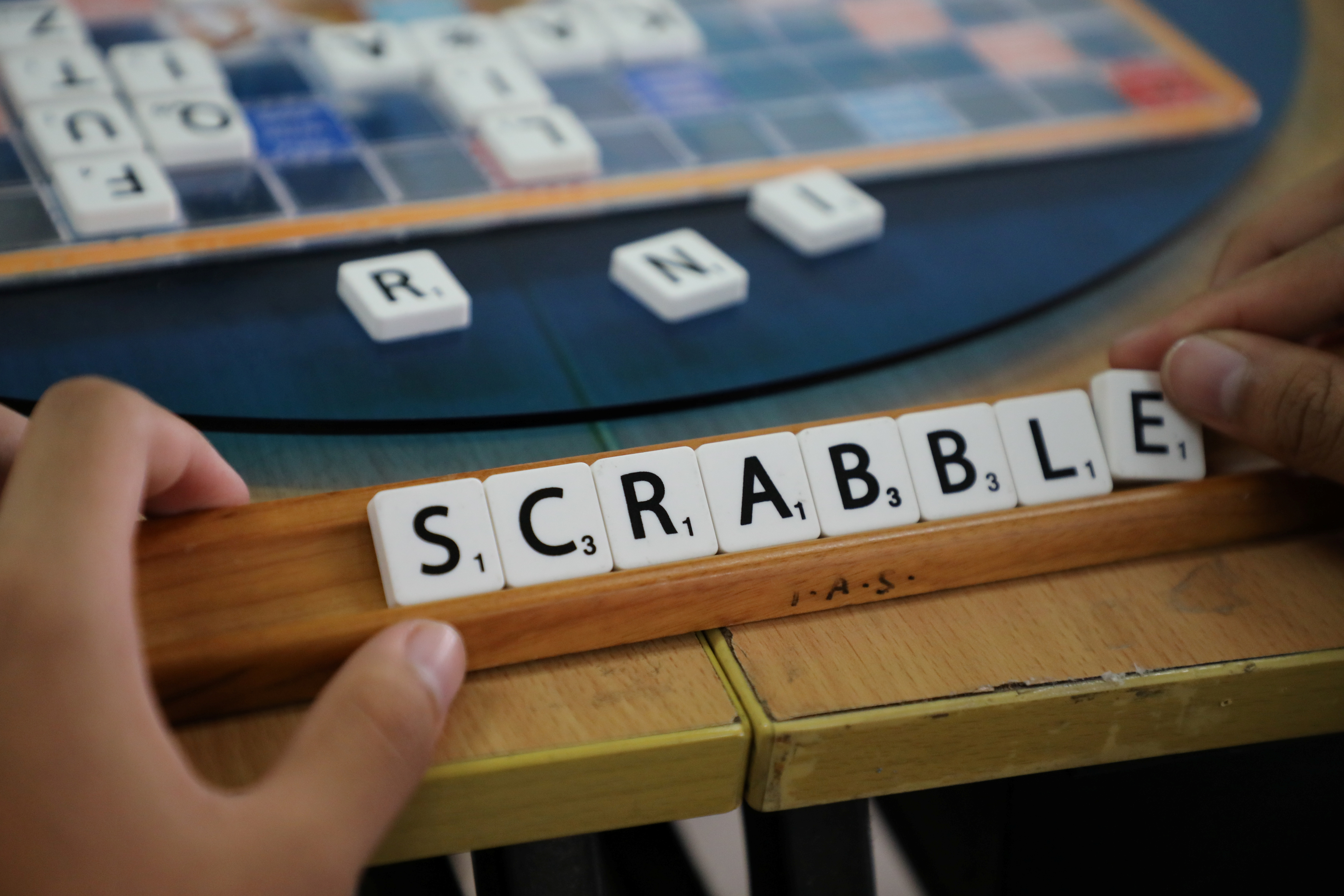 A player forms the word "Scrabble" with tiles during a practice session, in this posed picture taken in Kuala Lumpur, Malaysia