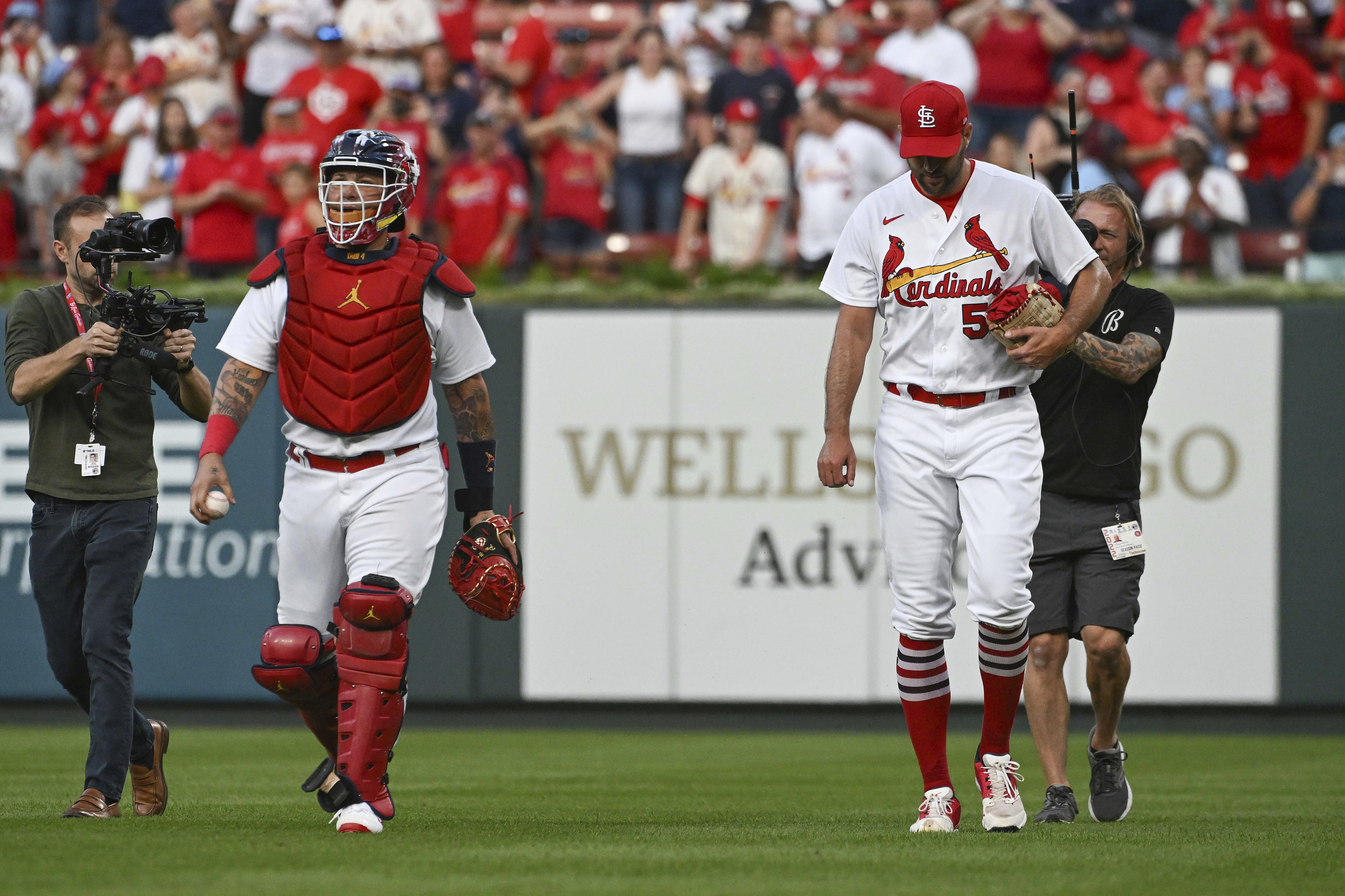 St. Louis Cardinals' Yadier Molina, left, and Adam Wainwright walk in from the bullpen after warming up for the team's baseball game against the Milwaukee Brewers on Wednesday Sept. 14, 2022, in St. Louis. (AP Photo/Joe Puetz)