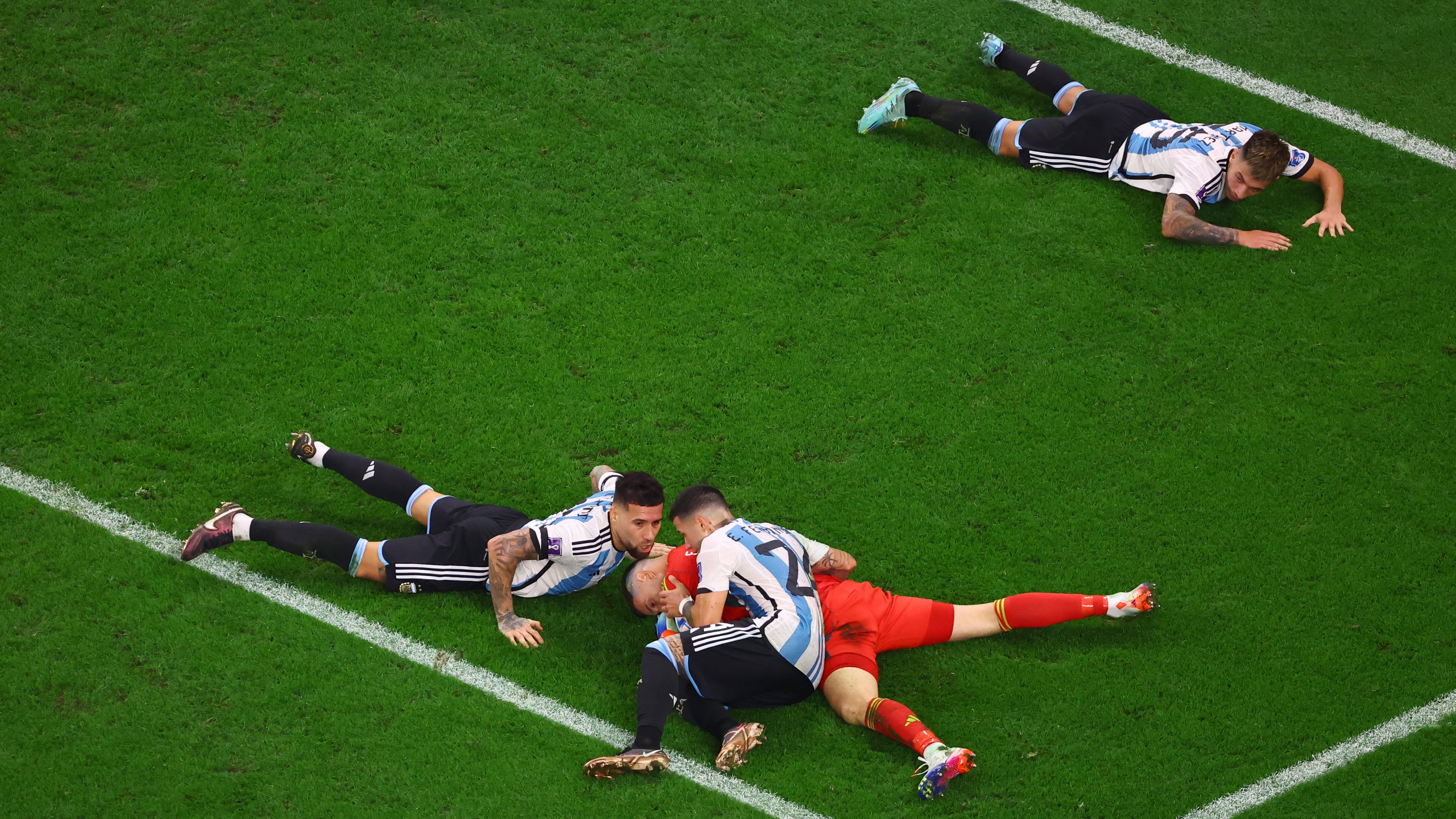 Soccer Football - FIFA World Cup Qatar 2022 - Round of 16 - Argentina v Australia - Ahmad bin Ali Stadium, Al Rayyan, Qatar - December 3, 2022 Argentina's Emiliano Martinez, Enzo Fernandez, Nicolas Otamendi and Lisandro Martinez celebrate progressing to the quarter finals REUTERS/Fabrizio Bensch