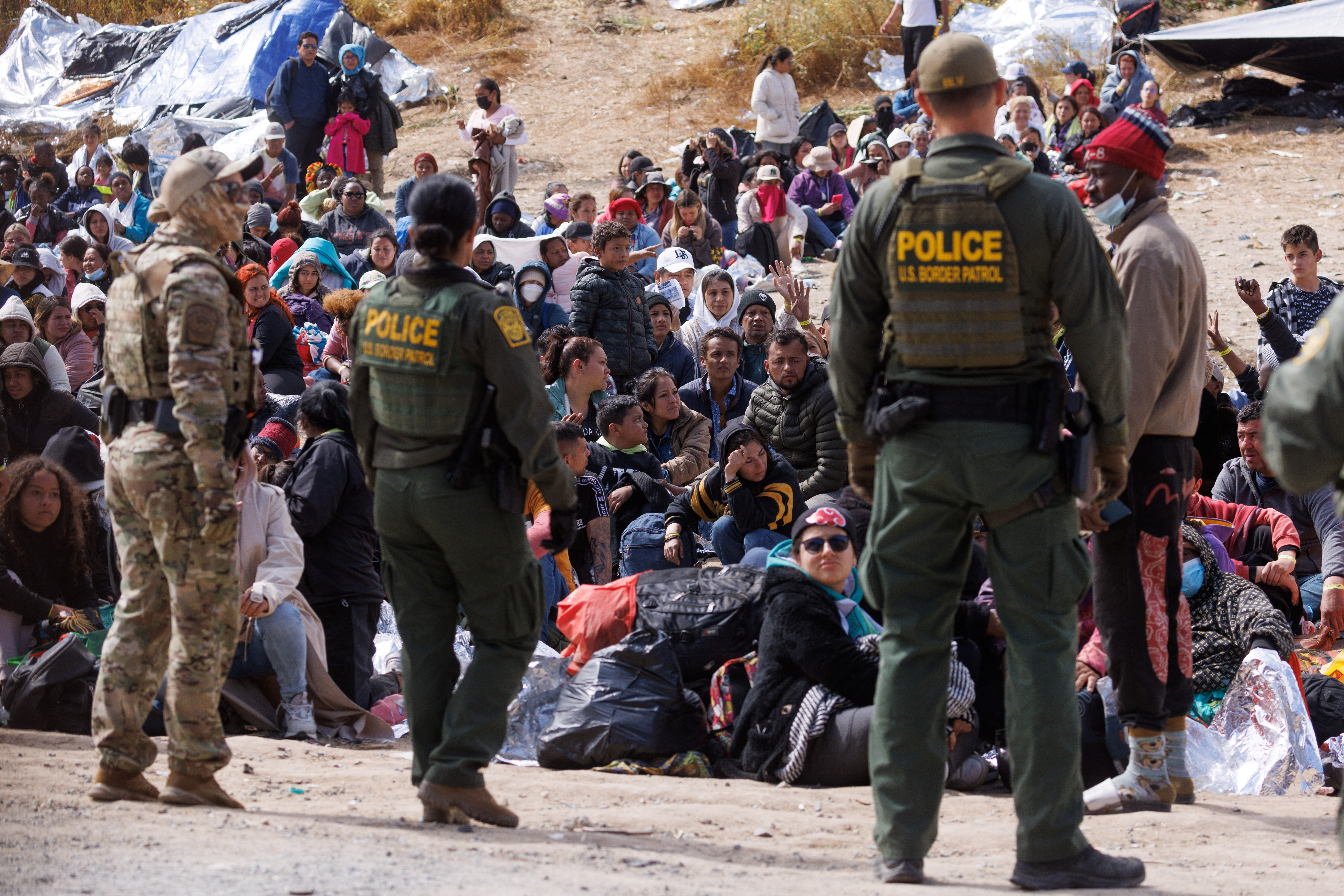 U.S. border patrol deal with a large group of migrants who have gathered between the primary and secondary border fences as the United States prepares to lift COVID-19 era Title 42 restrictions that have blocked migrants at the U.S.-Mexico border from seeking asylum since 2020, near San Diego, California, U.S., May 11, 2023. REUTERS/Mike Blake