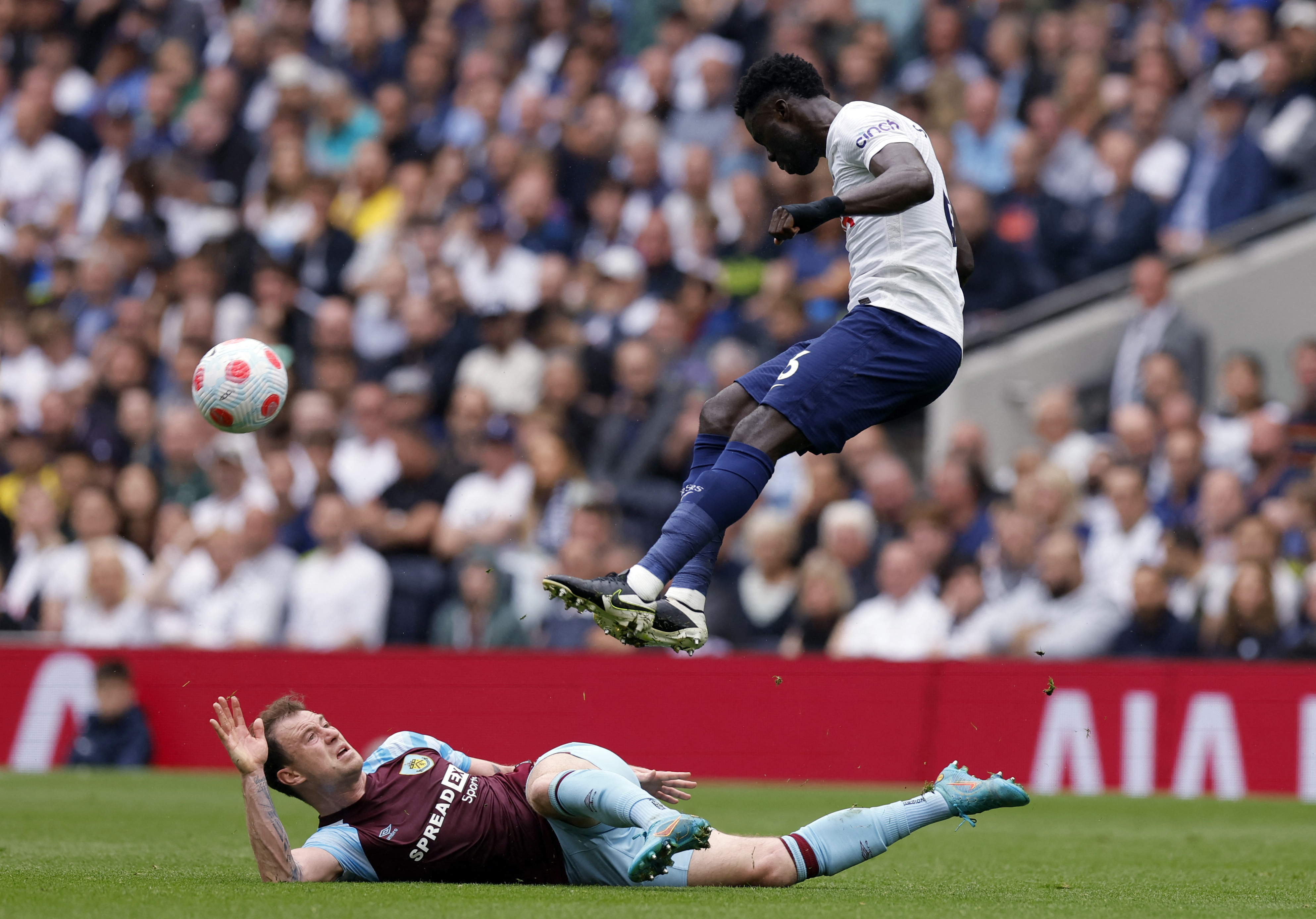 Soccer Football - Premier League - Tottenham Hotspur v Burnley - Tottenham Hotspur Stadium, London, Britain - May 15, 2022 Burnley's Ashley Barnes in action with Tottenham Hotspur's Davinson Sanchez Action Images via Reuters/Andrew Couldridge EDITORIAL USE ONLY. No use with unauthorized audio, video, data, fixture lists, club/league logos or 'live' services. Online in-match use limited to 75 images, no video emulation. No use in betting, games or single club /league/player publications.  Please contact your account representative for further details.