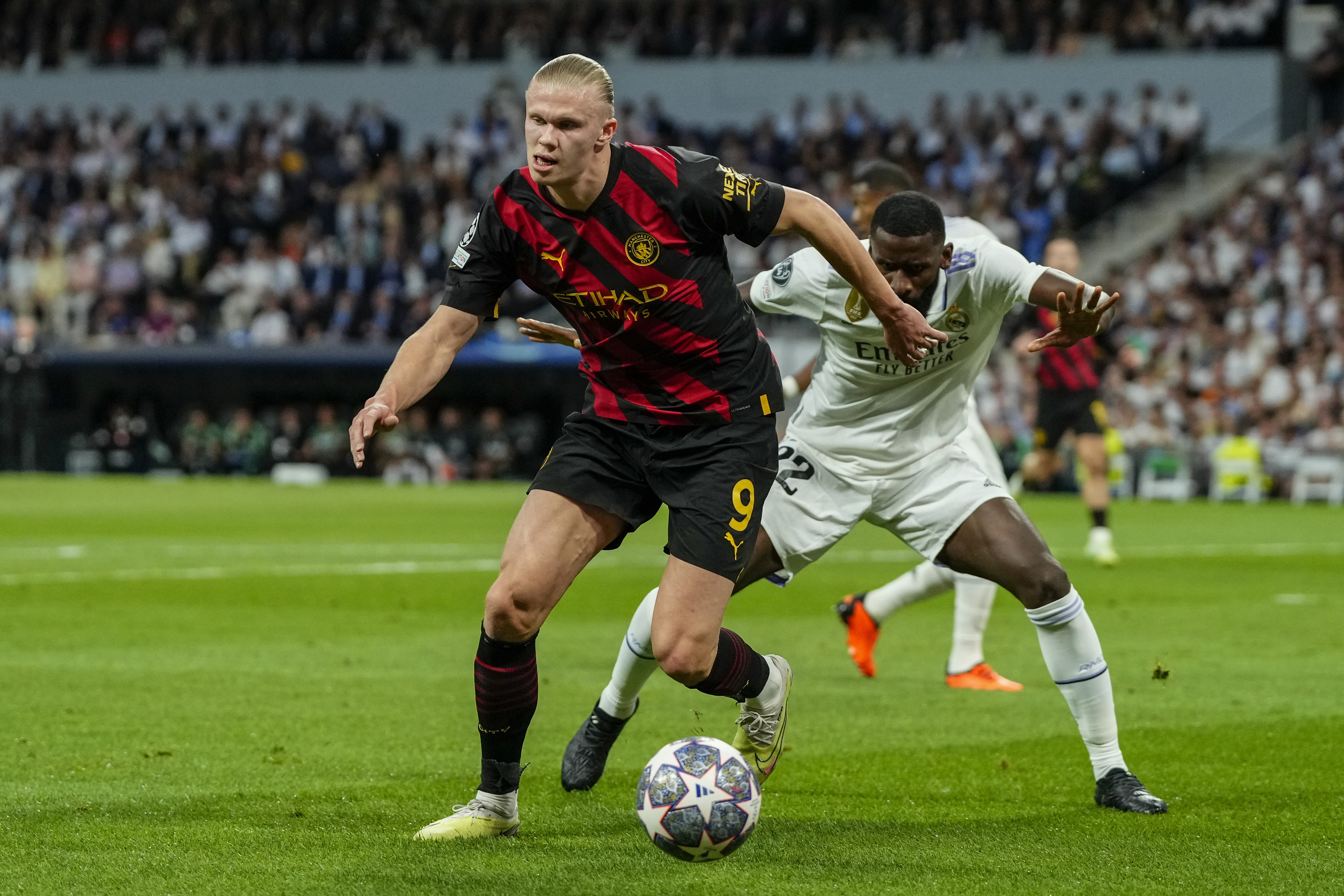 Erling Haaland battles for the ball with Antonio Rudiger in the first leg of the semifinals. 