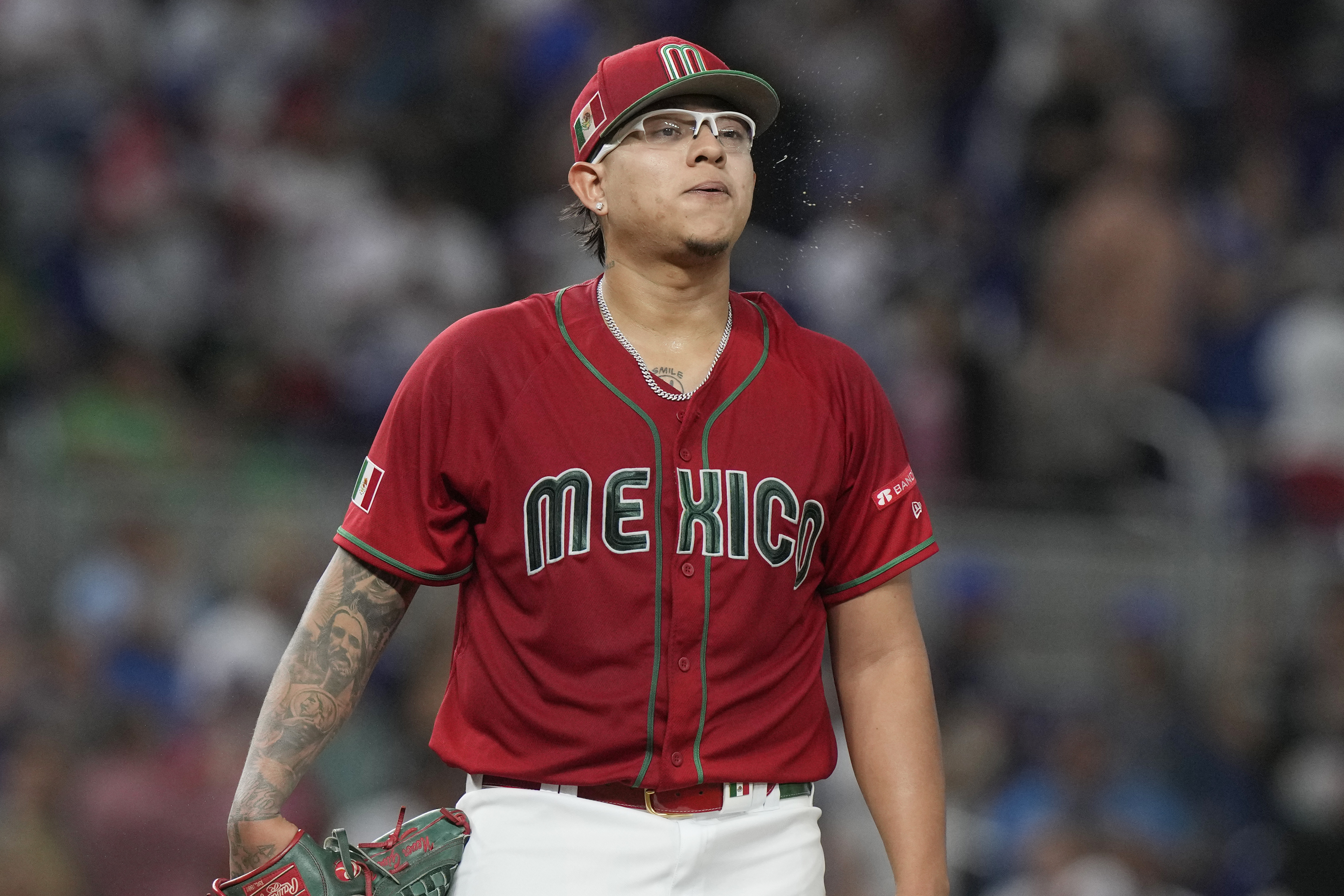 Julio Urias (7), Mexican starter, reacts after allowing a second home run to Puerto Rico, and allowing four runs in the first inning in the baseball game at the World Classic, Friday, March 17, 2023, in Miami.  (AP Photo/Marta Lavandier)