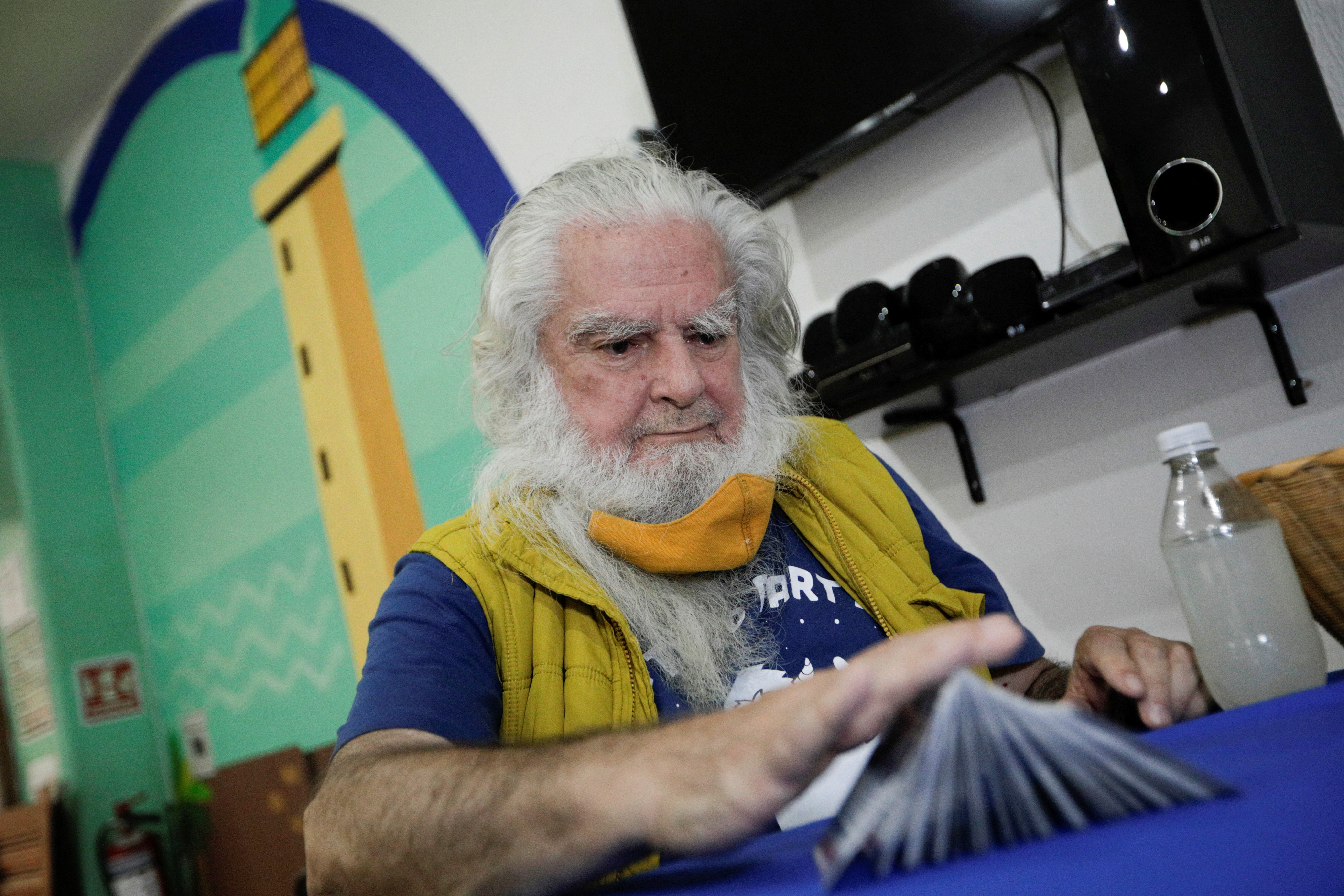 Antonio Vazquez Alba "Brujo Mayor", also known as Mexico's Grand Warlock, shuffles tarot cards during a ceremony to make his predictions for the year 2022, in Mexico City, Mexico January 5, 2022. REUTERS/Luis Cortes