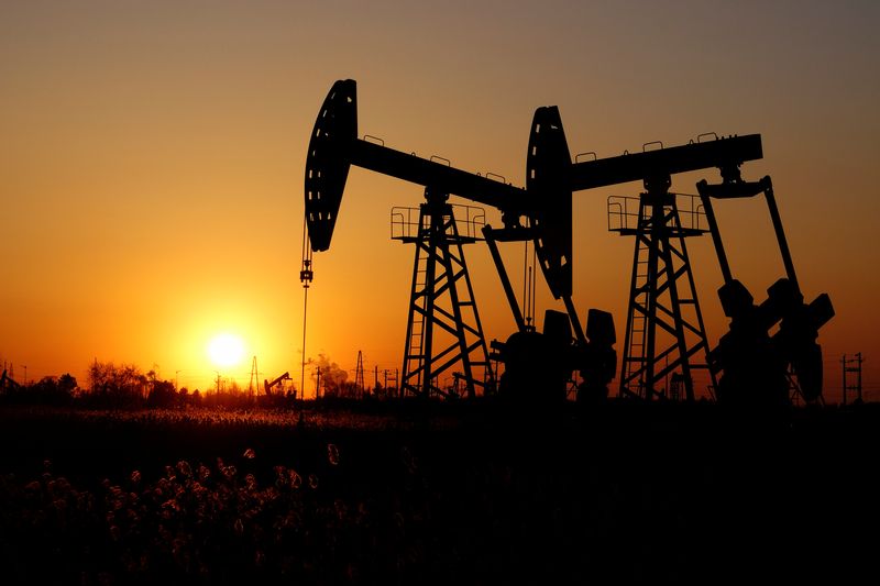 FILE PHOTO: Oil rockers are seen against a sunset at the Daqing oil field in China's Heilongjiang province.  December 7, 2018. REUTERS/Stringer/File