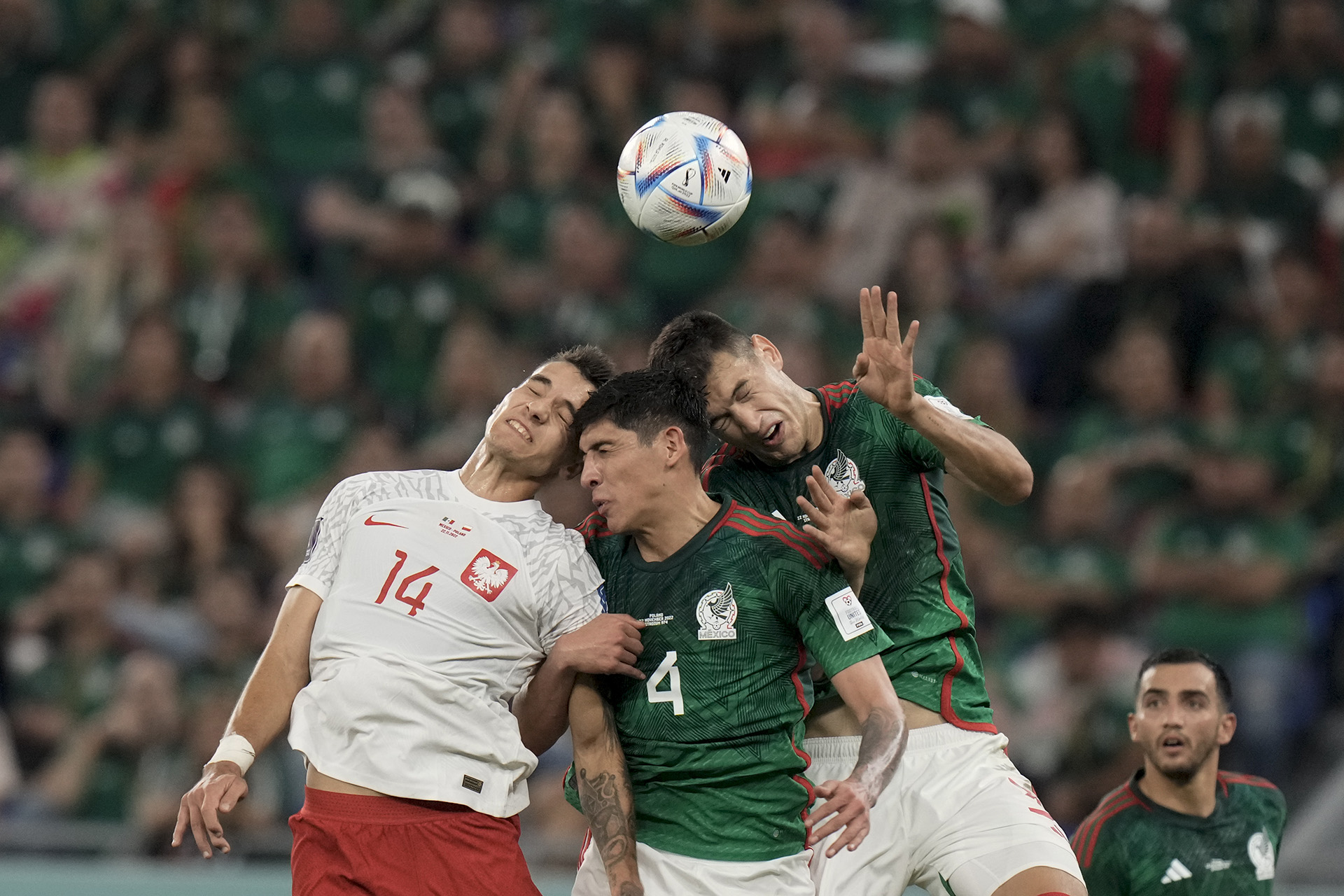 Mexico's Cesar Montes, right, and Edson Alvarez, center, fight for the ball with Poland's Jakub Kiwior during the World Cup group C soccer match between Mexico and Poland, at the Stadium 974 in Doha, Qatar, Tuesday, Nov. 22, 2022. (AP Photo/Moises Castillo)