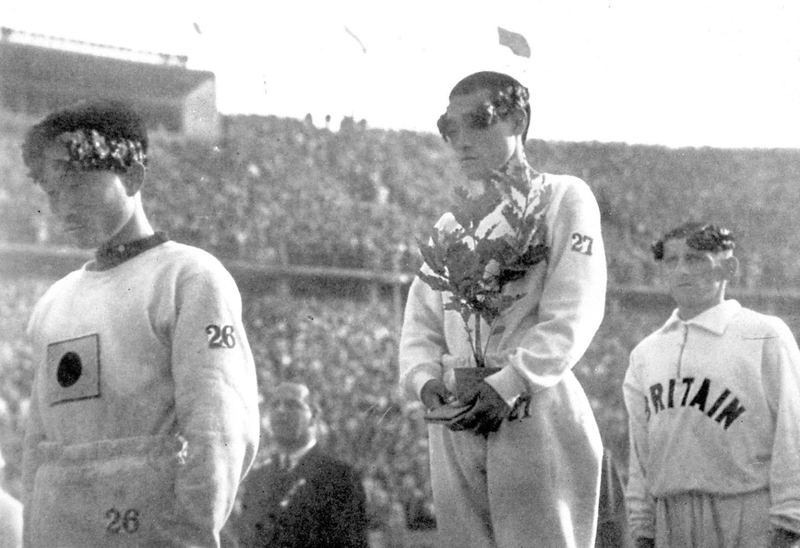 The gold medallist for a marathon at the 1936 Berlin Olympic Games, Sohn Kee-chung stands on the podium with his head lowered instead of looking at Japan's rising-sun flag in this photo taken in Berlin, 1936. Picture taken in 1936. Mandatory credit Kyodo/via REUTERS ATTENTION EDITORS - THIS IMAGE WAS PROVIDED BY A THIRD PARTY. MANDATORY CREDIT. JAPAN OUT. NO COMMERCIAL OR EDITORIAL SALES IN JAPAN.