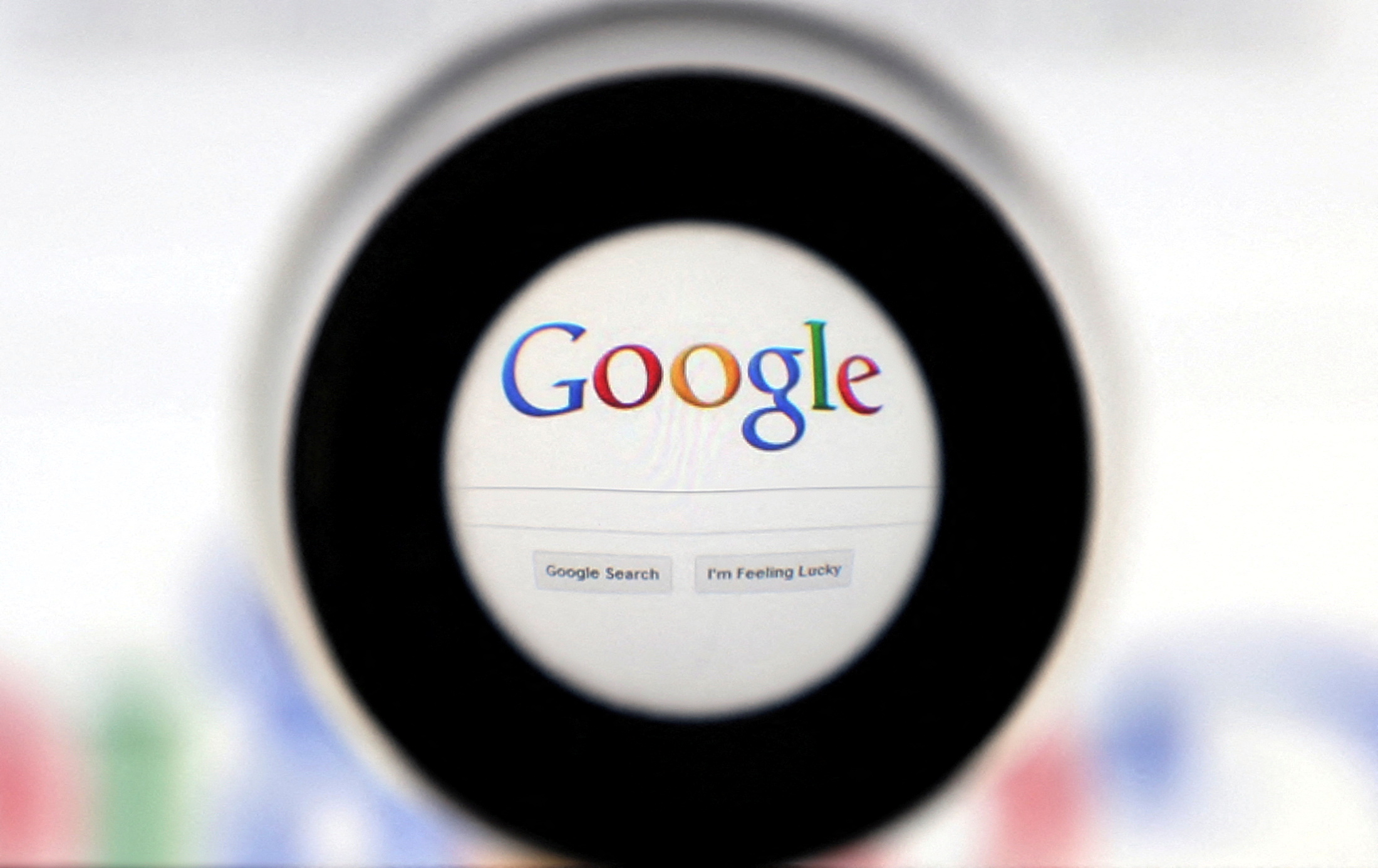 FILE PHOTO: A Google search page is seen through a magnifying glass in this photo illustration taken May 30, 2014.    REUTERS/Francois Lenoir/File Photo