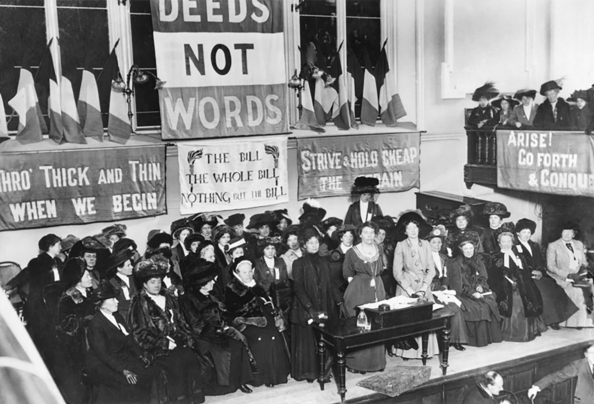A suffrage meeting at Caxton Hall, Manchester, England, circa 1908. Emmeline Pethick-Lawrence and Emmeline Pankhurst stand in the center of the pulpit.  The New York Times / Wikimedia Commons