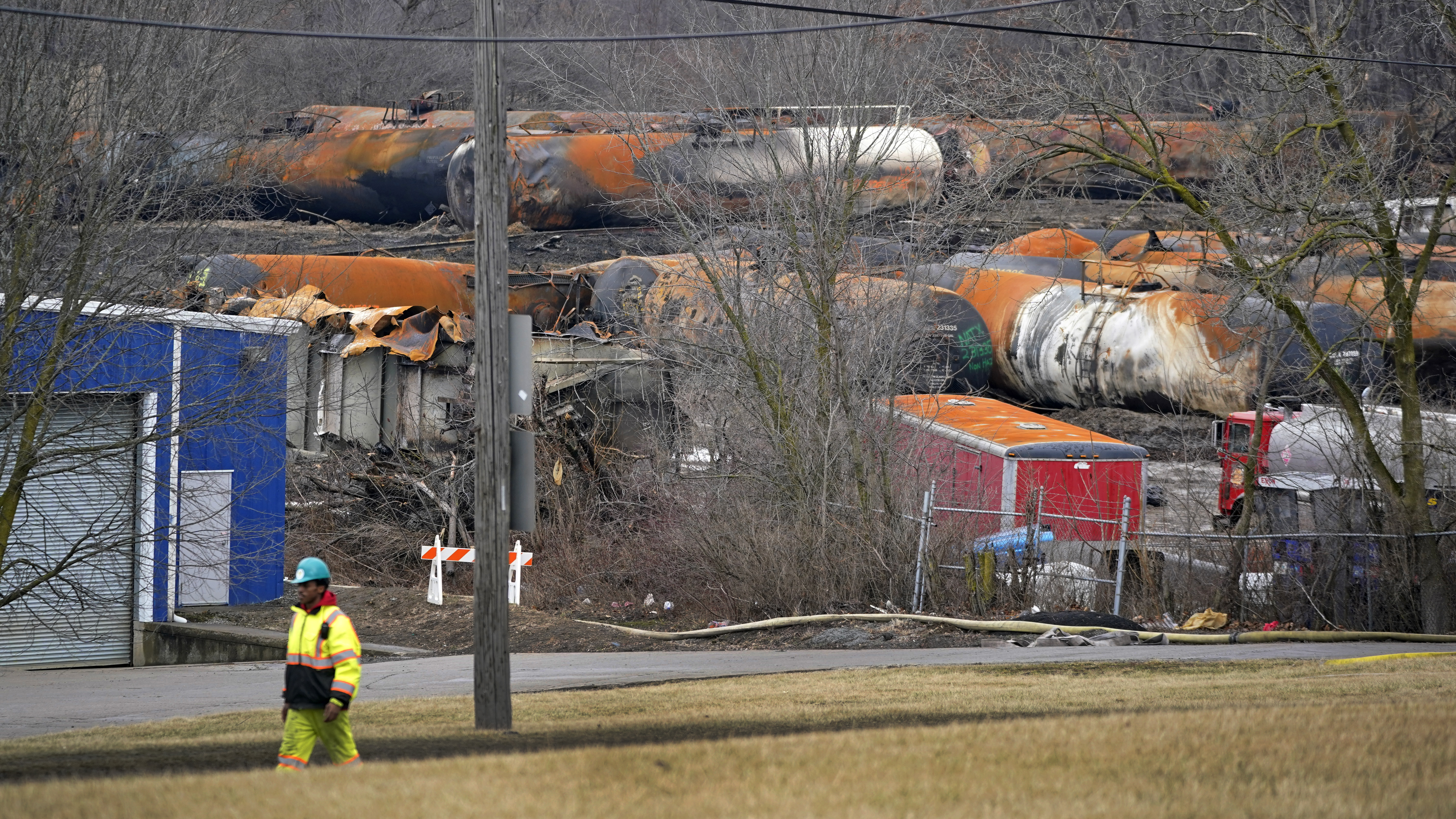 FILE - Workers clean up several cars of a Norfolk Southern train that derailed in East Palestine, Ohio, on Feb. 9, 2023. (AP Photo/Gene J. Puskar, File)