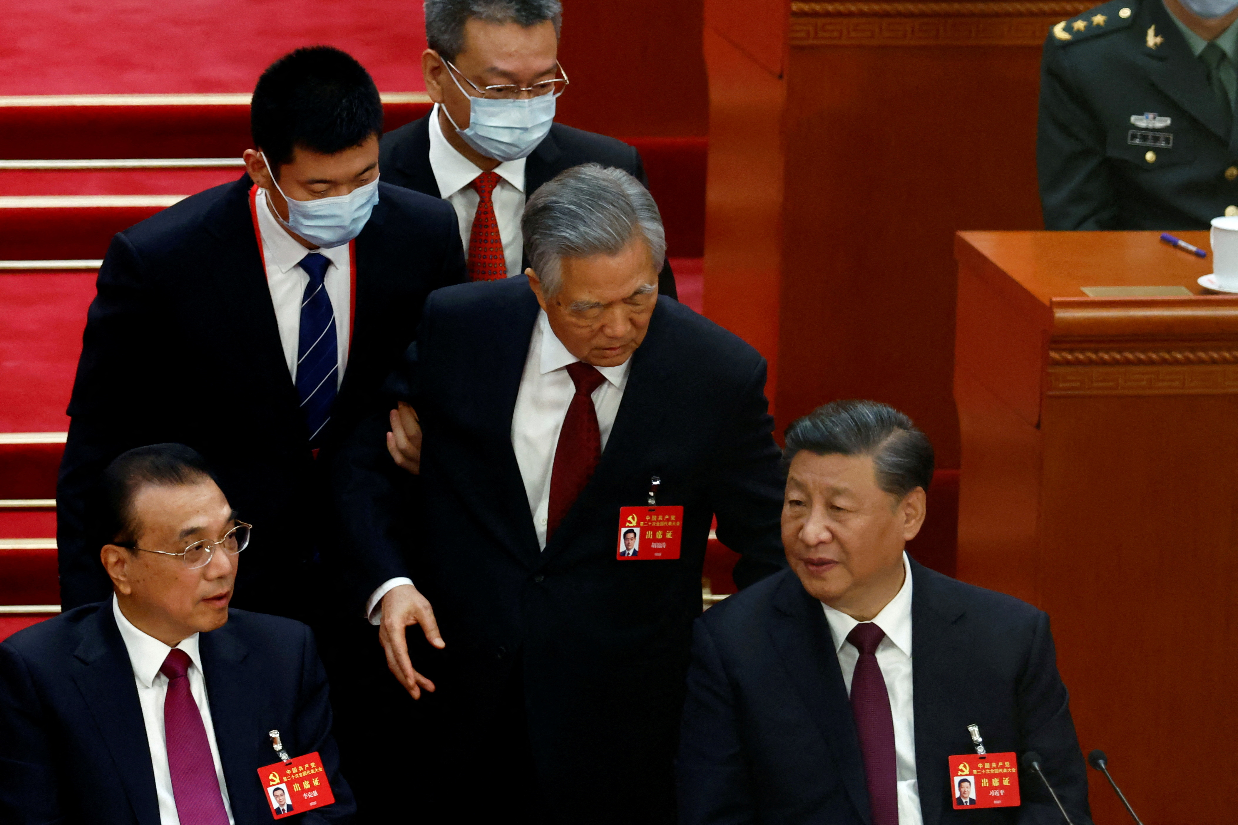 Hu eventually left the room, though he had a few brief words with Xi (REUTERS/Tingshu Wang/File Photo)