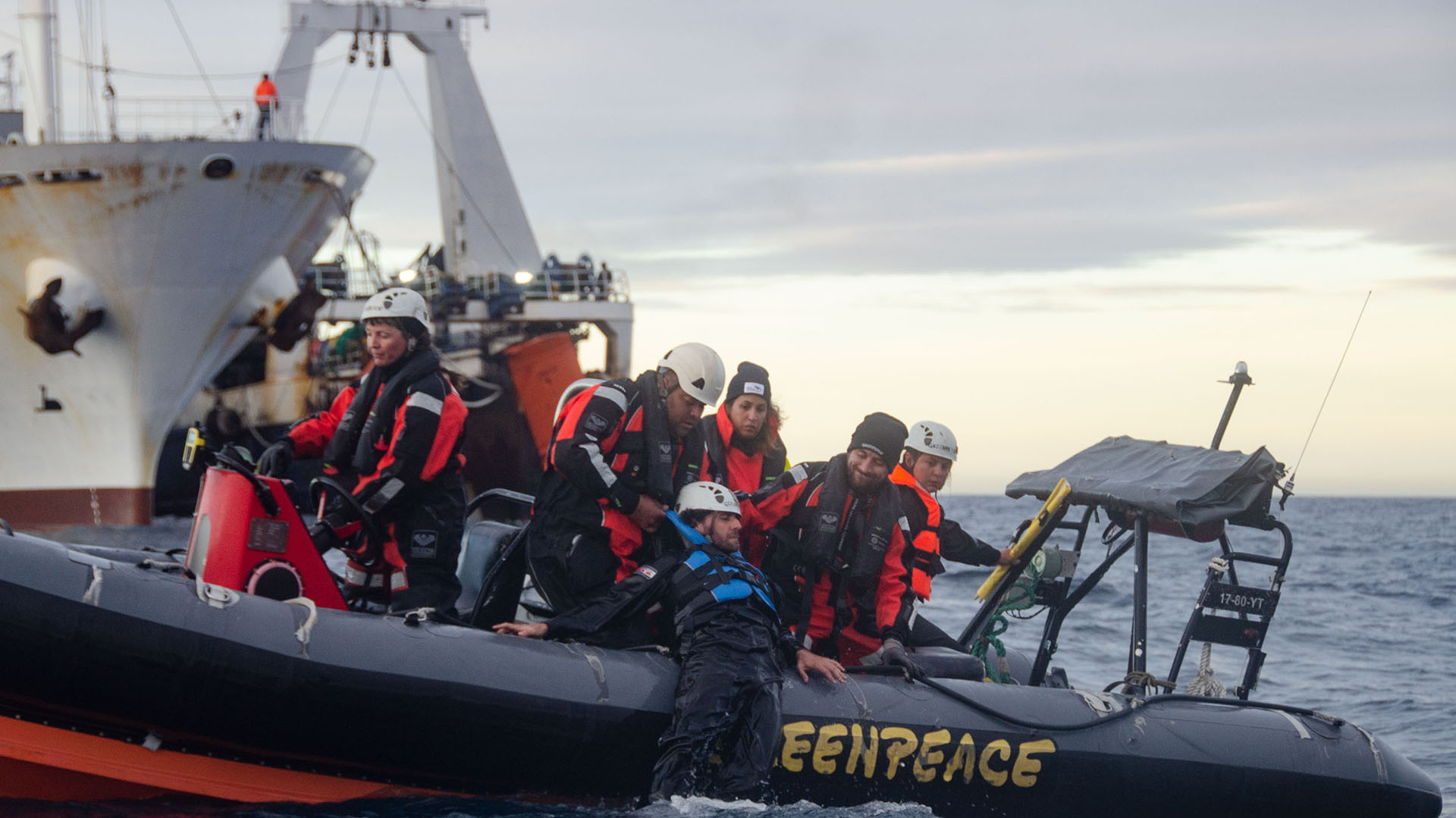 Juan Francisco Barcia, uno de los voluntarios de Greenpeace que realizaron la acción en alta mar, es izado en uno de los gomones (Matías Arbotto)