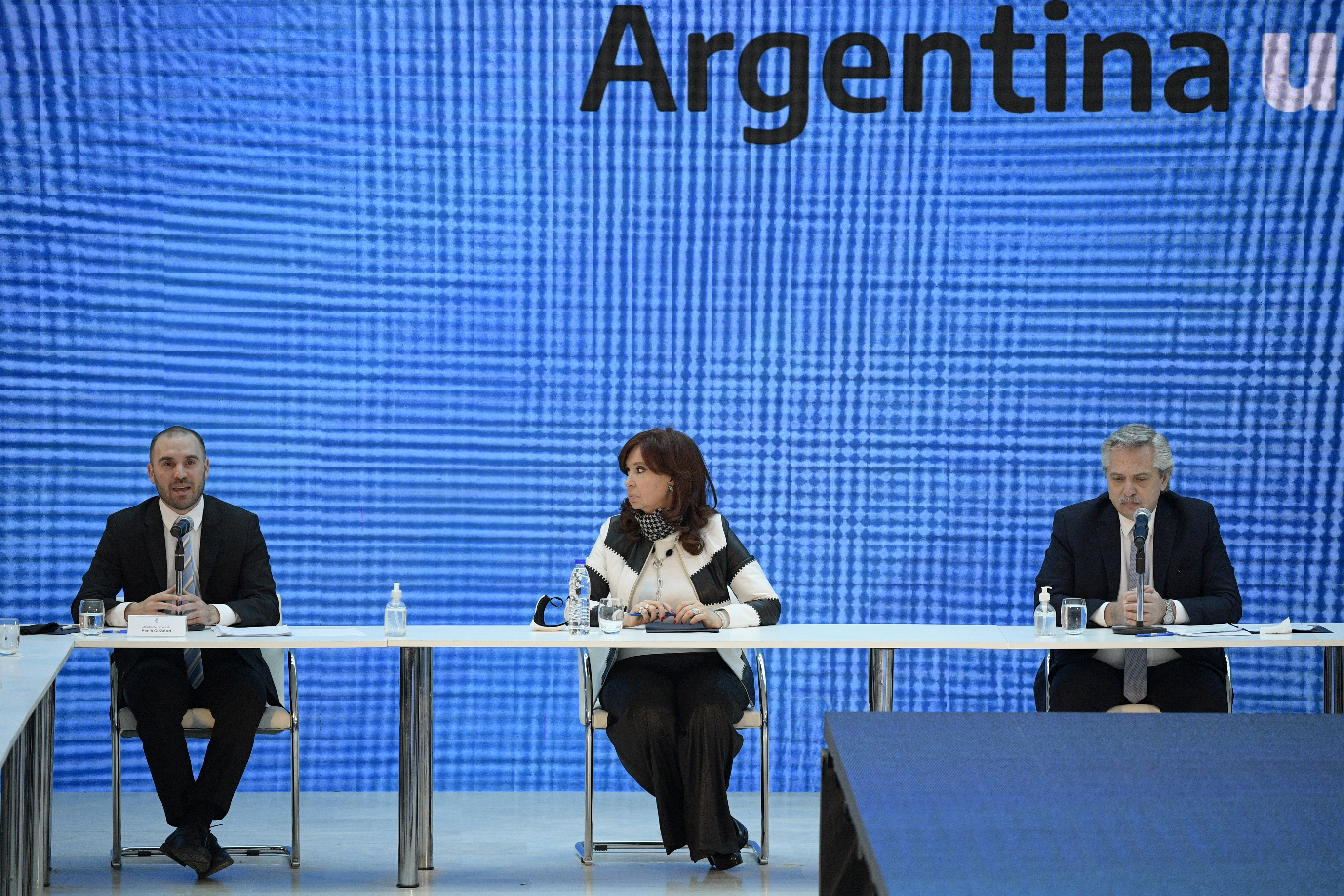 Argentina's President Alberto Fernandez (R), Vice President Cristina Fernandez de Kirchner and Economy Minister Martin Guzman attend a news conference to give details about the agreement with major private creditors to restructure Argentina's sovereign debt, at the Casa Rosada Presidential Palace, in Buenos Aires, Argentina August 31, 2020. Juan Mabromata/Pool via REUTERS