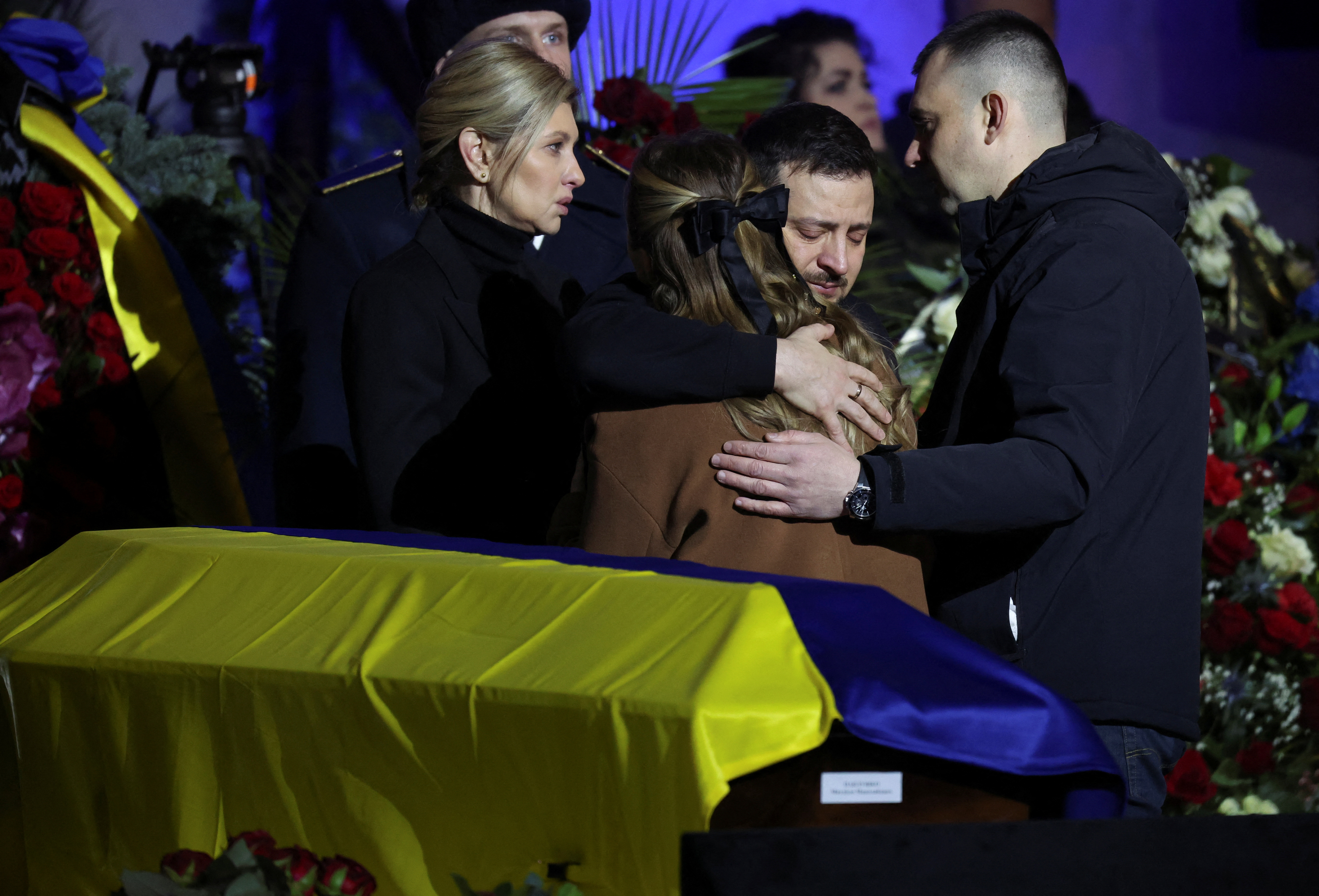 Ukraine's President Volodimir Zelensky and First Lady Olena Zelenska offer their condolences at a memorial service for Ukrainian Interior Minister Denys Monastyrskyi, his deputy and officials who died in the helicopter crash near kyiv, in kyiv, Ukraine, January 21, 2023. REUTERS/Nacho Doce
