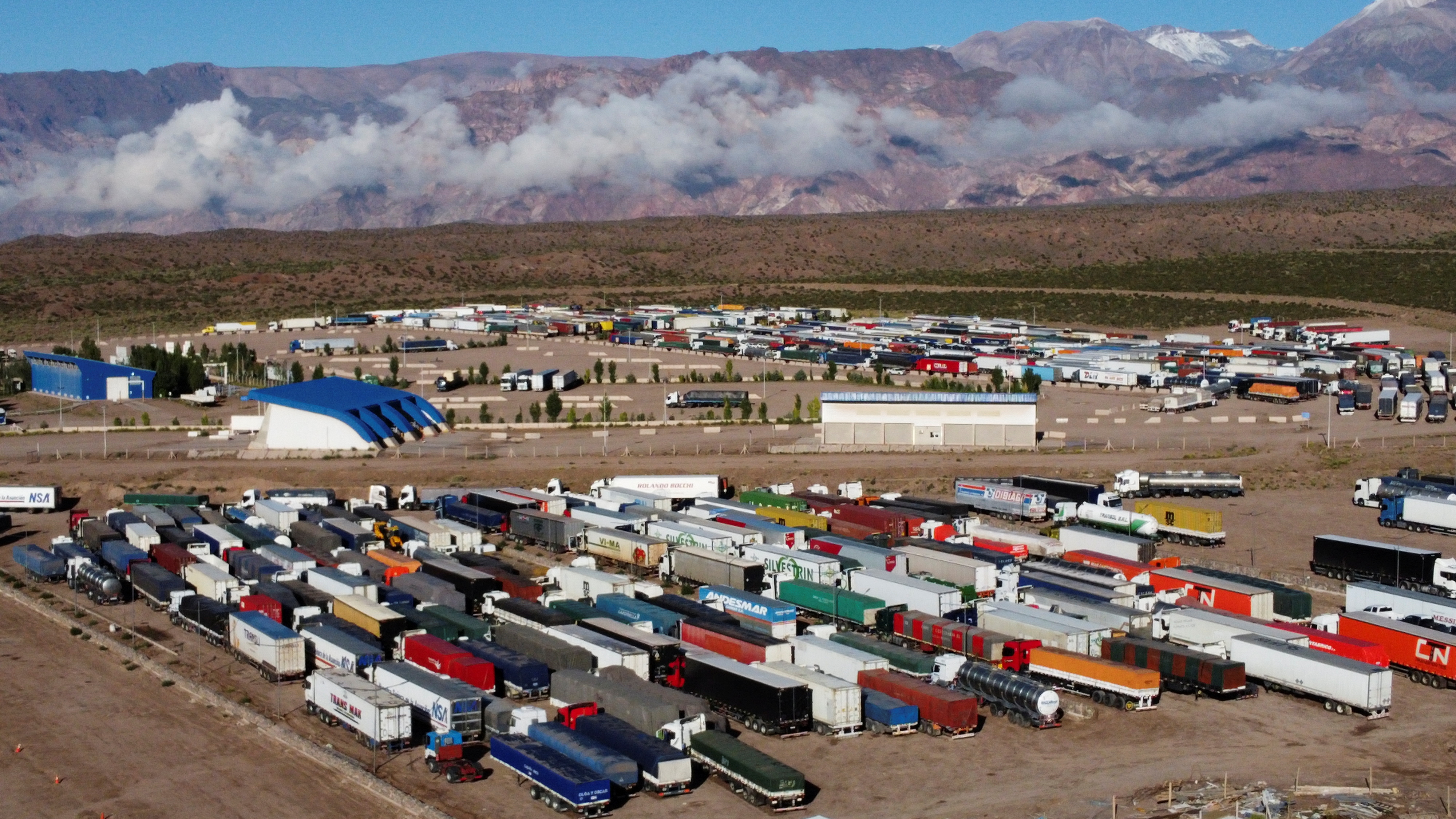 Parked trucks are pictured at the Argentine border with Chile as the drivers wait to be tested for the coronavirus disease (COVID-19) at the Argentine border with Chile, after Chile tightened the entry protocols to the country, in Uspallata, Mendoza, Argentina January 28, 2022. Picture taken with a drone.  REUTERS/Maximiliano Rios NO RESALES. NO ARCHIVES.