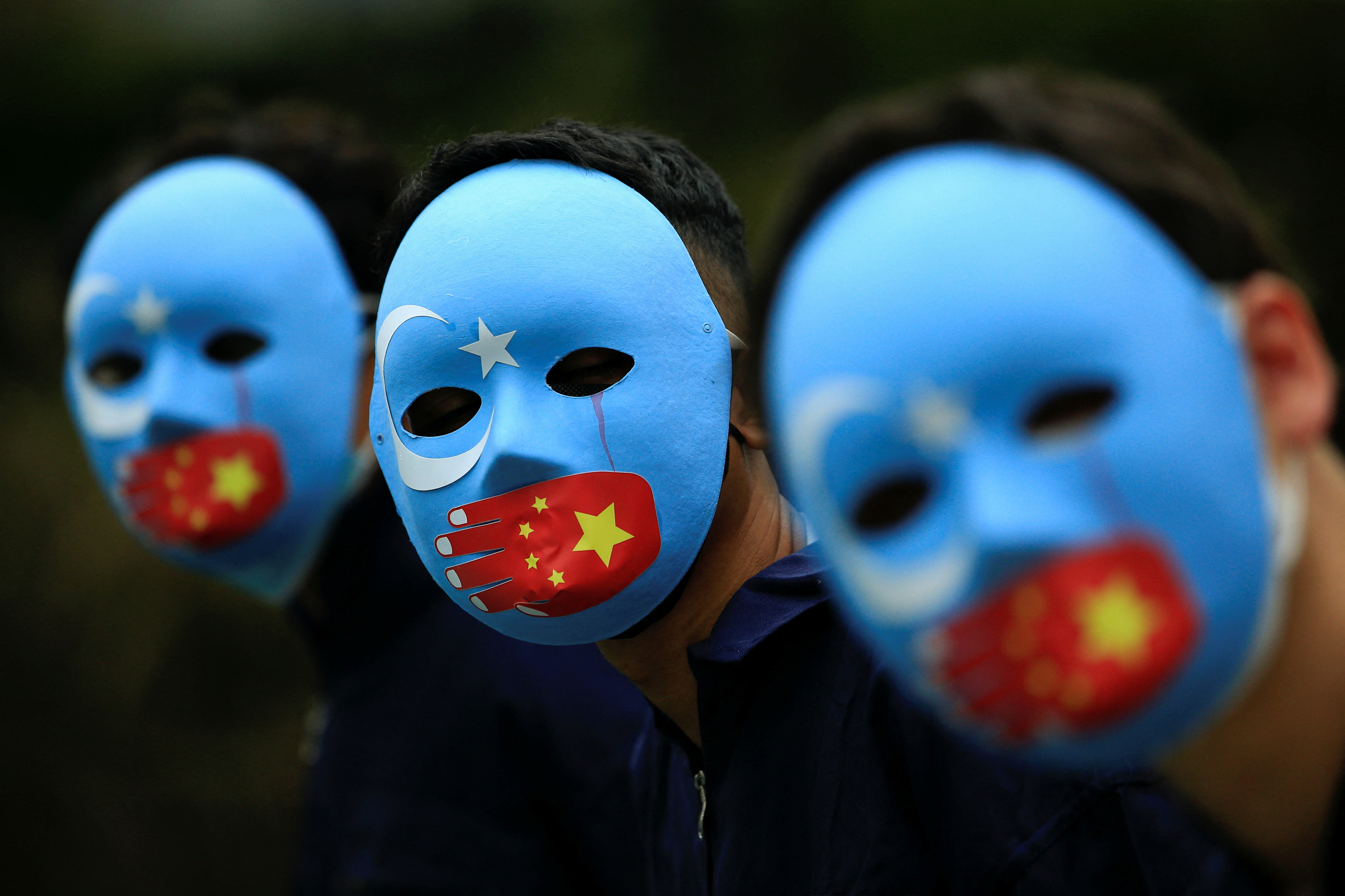 Activists take part in a protest against China's treatment towards the ethnic Uyghur people and calling for a boycott of the 2022 Winter Olympics in Beijing, at a park Jakarta, Indonesia, January 4, 2022. REUTERS/Willy Kurniawan