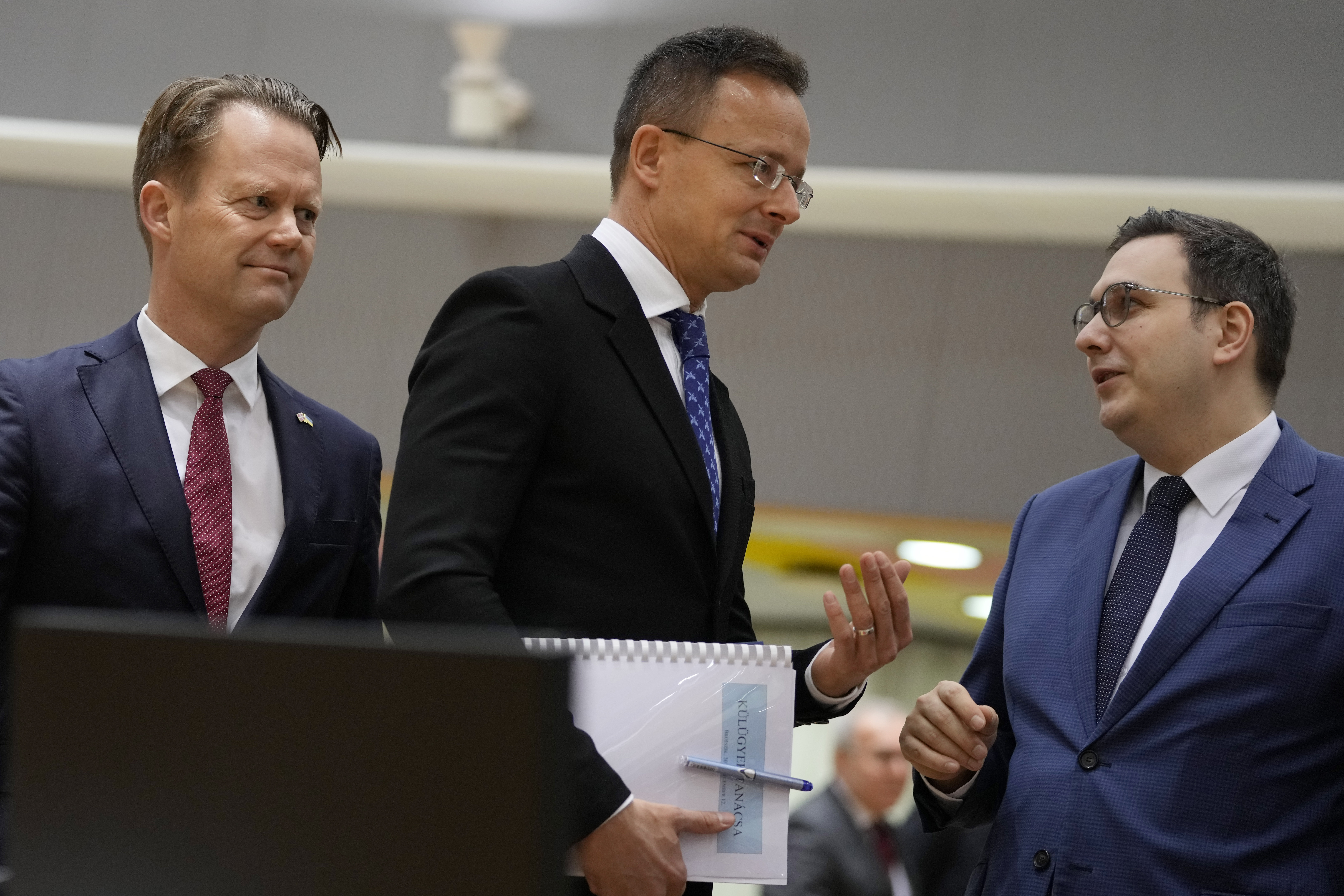 El ministro de Relaciones Exteriores de Hungría, Peter Szijjarto, centro, conversa con sus homólogos de la República Checa, Jan Lipavsky, derecha, y de Dinamarca, Jeppe Kofod, durante una reunión de ministros de Relaciones Exteriores de la Unión Europea en Bruselas, el lunes 12 de diciembre de 2022. (AP Foto/Virginia Mayo)