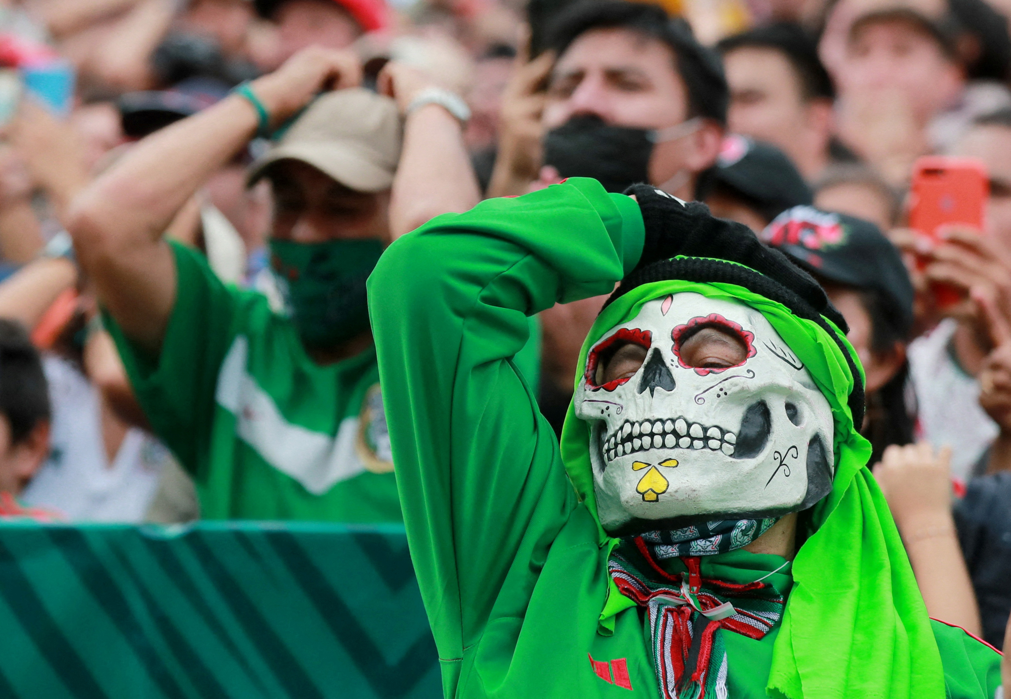 Soccer Football - FIFA World Cup Qatar 2022 - Fans in Mexico City watch Saudi Arabia v Mexico - Mexico City, Mexico - November 30, 2022 A Mexico fan wearing a mask reacts in Mexico City during the Saudi Arabia v Mexico match REUTERS/Henry Romero     TPX IMAGES OF THE DAY