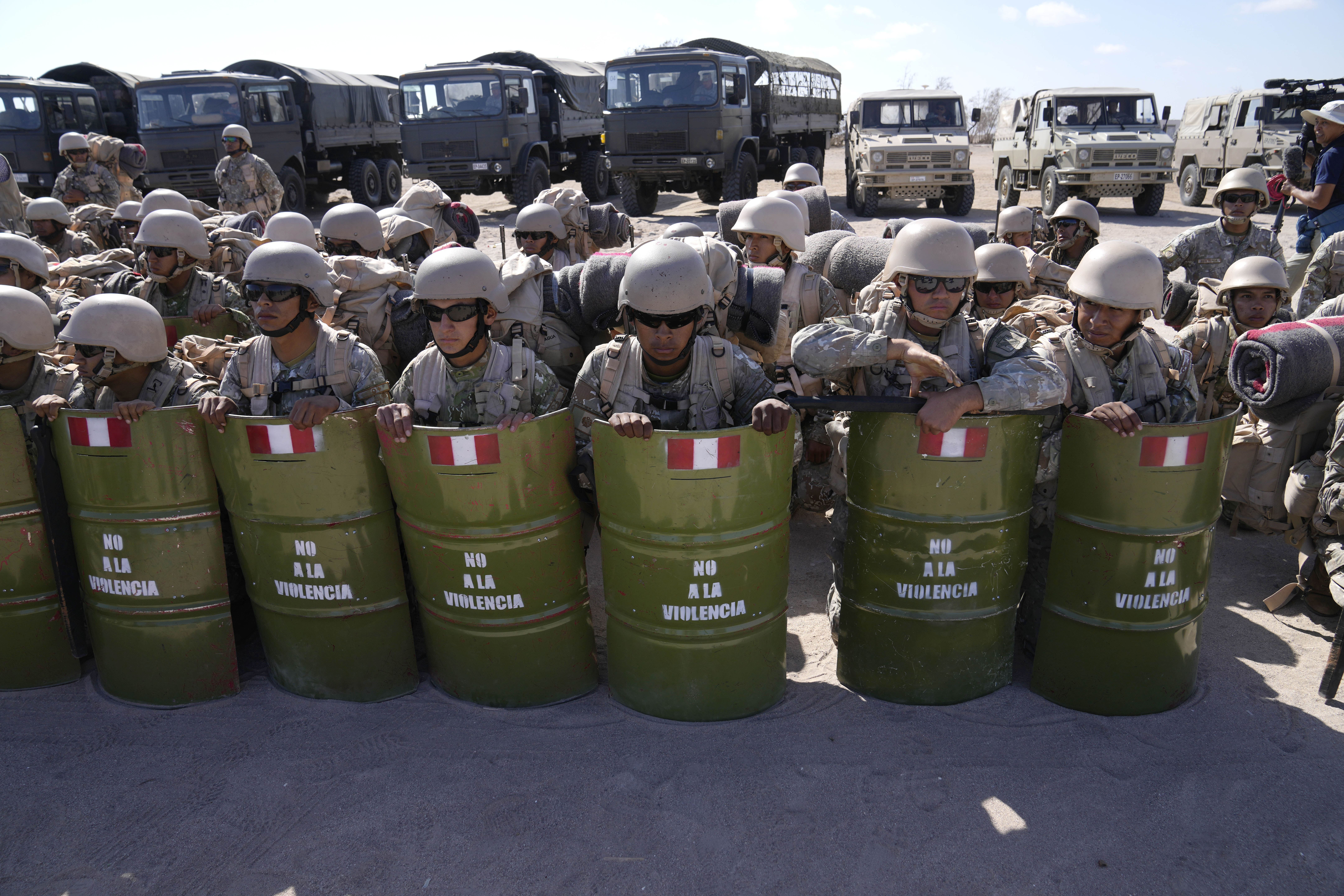 Peruvian service members prepare for deployment to the country's border with Chile, in Tacna, Peru, Friday, April 28, 2023. The migration crisis on the Chile-Peru border intensified on Thursday with hundreds of migrants stranded in the border limit, without being able to cross into Peru.  (AP Photo/Martín Mejía)