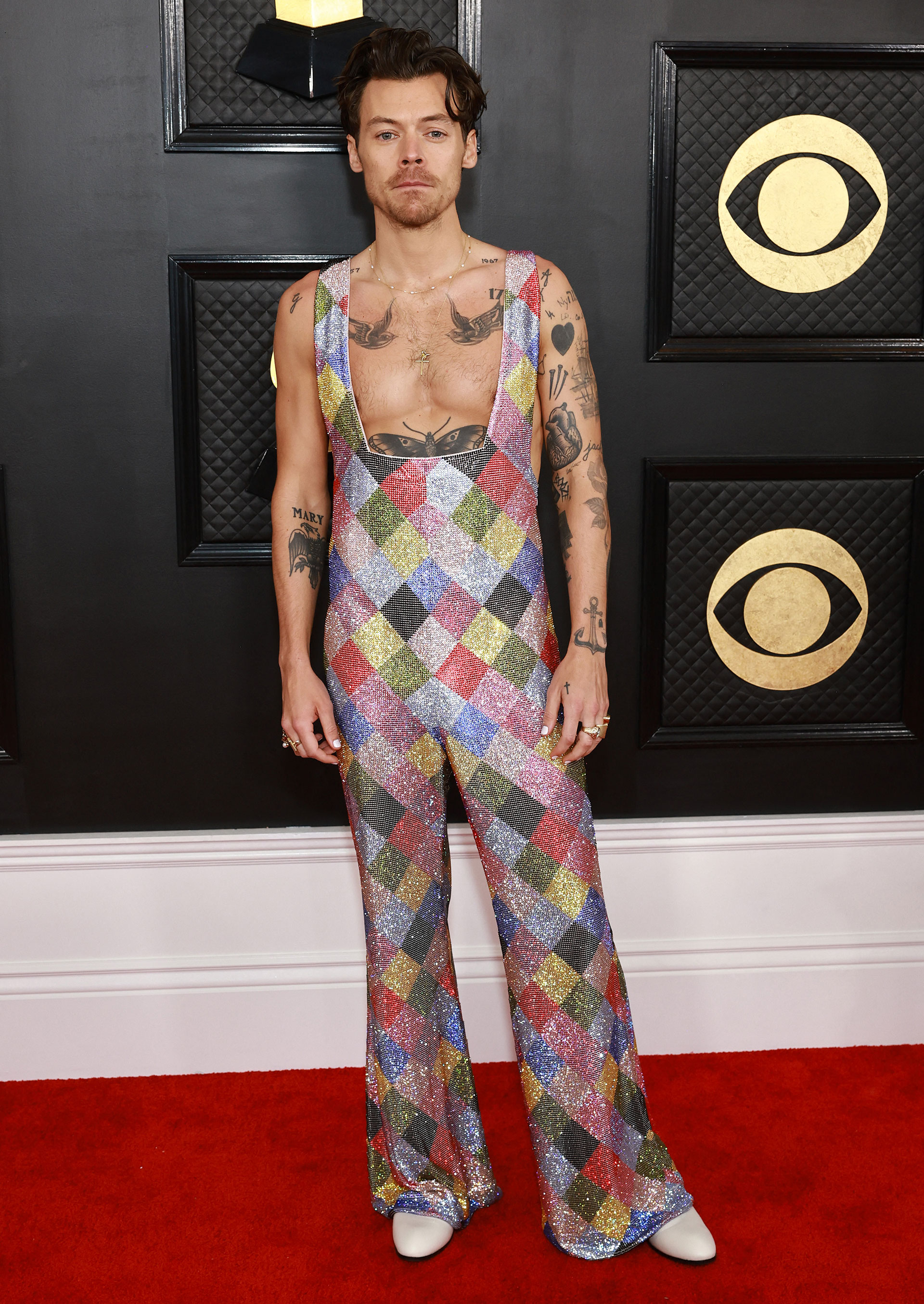 Harry Styles arrived on the red carpet in a single garment with straps and long legs (AFP)