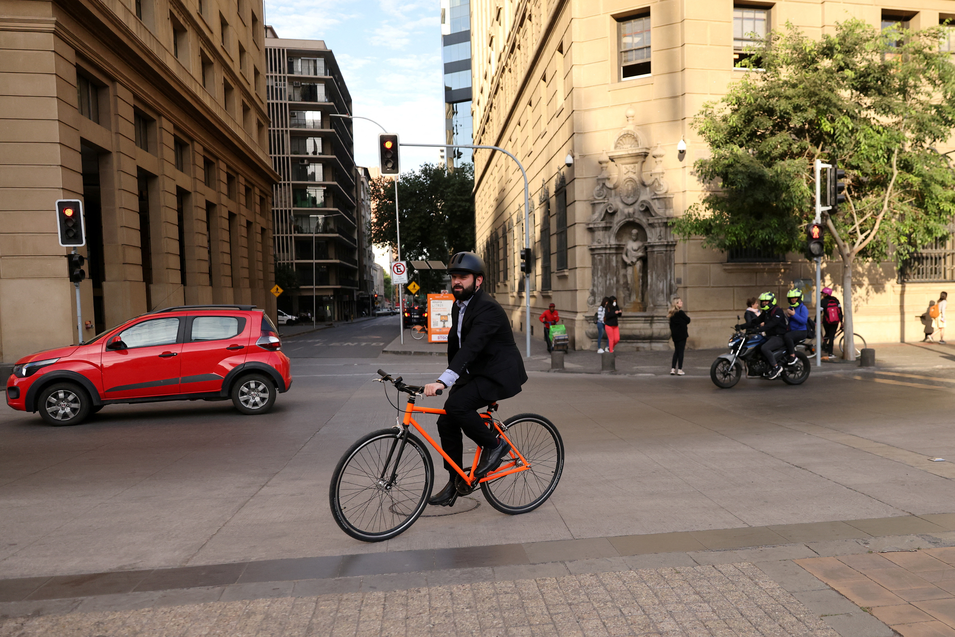 Boric, on his bicycle, on a central street in Santiago.